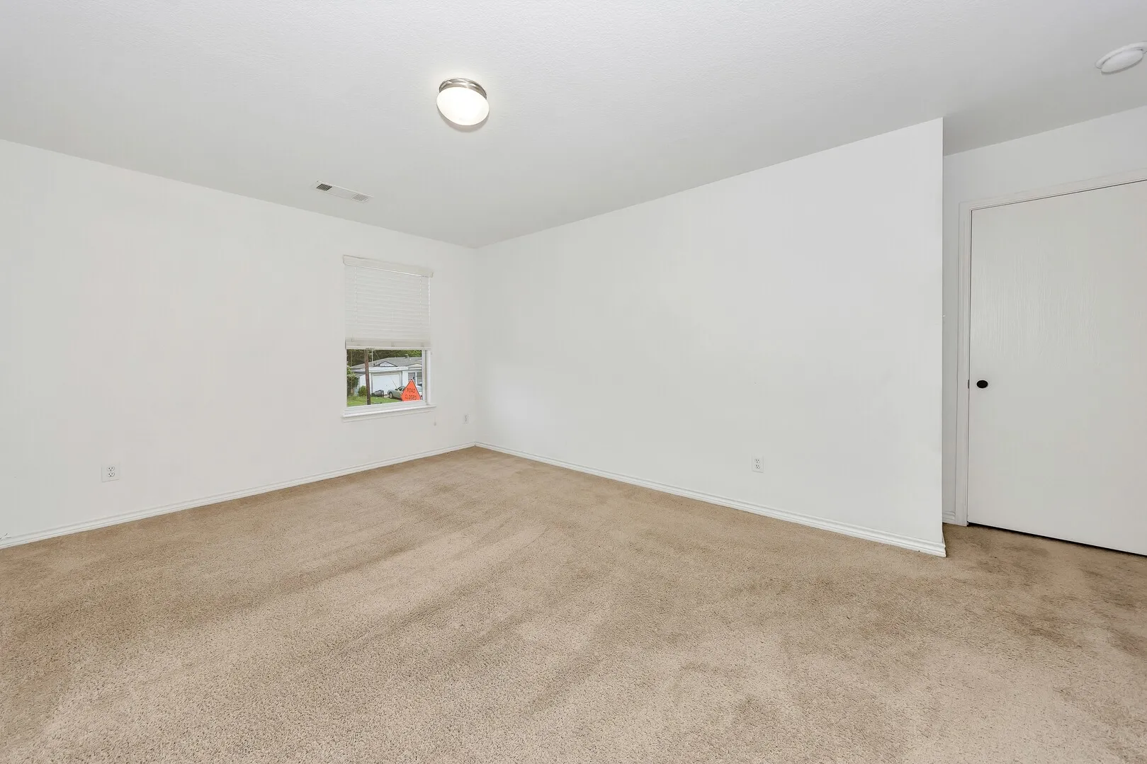 Carpeted spare room with baseboards