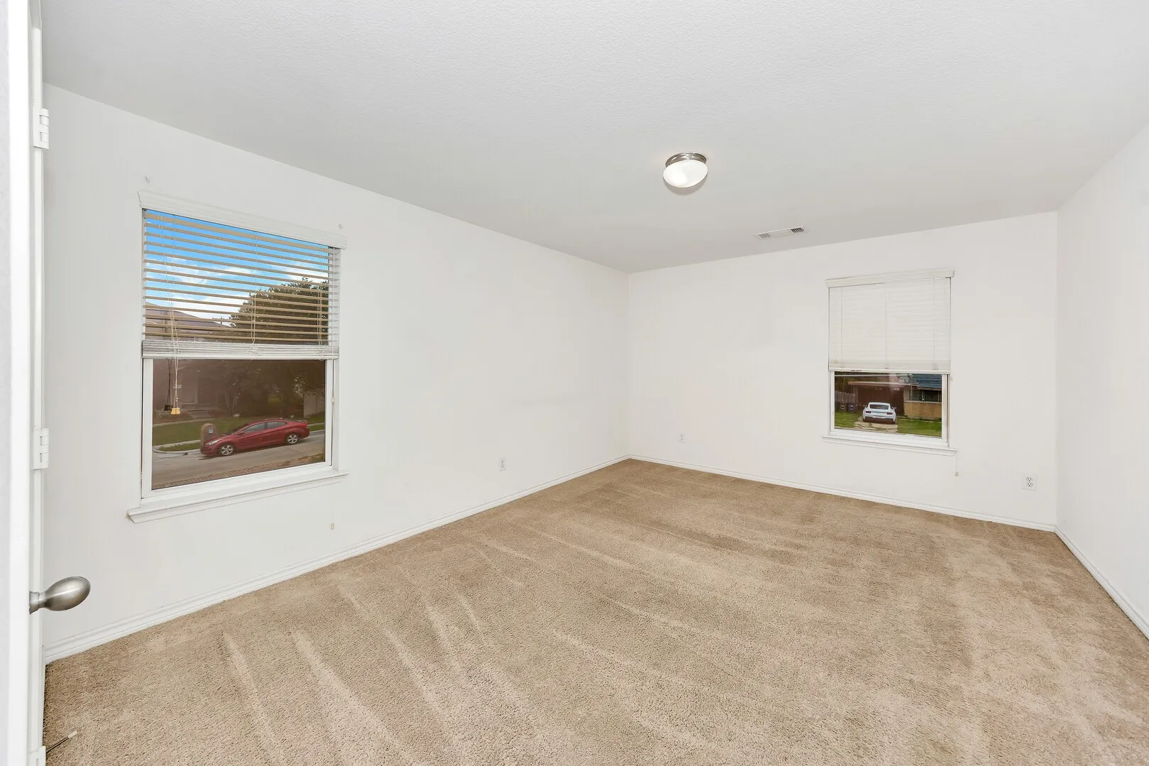 Carpeted empty room with baseboards