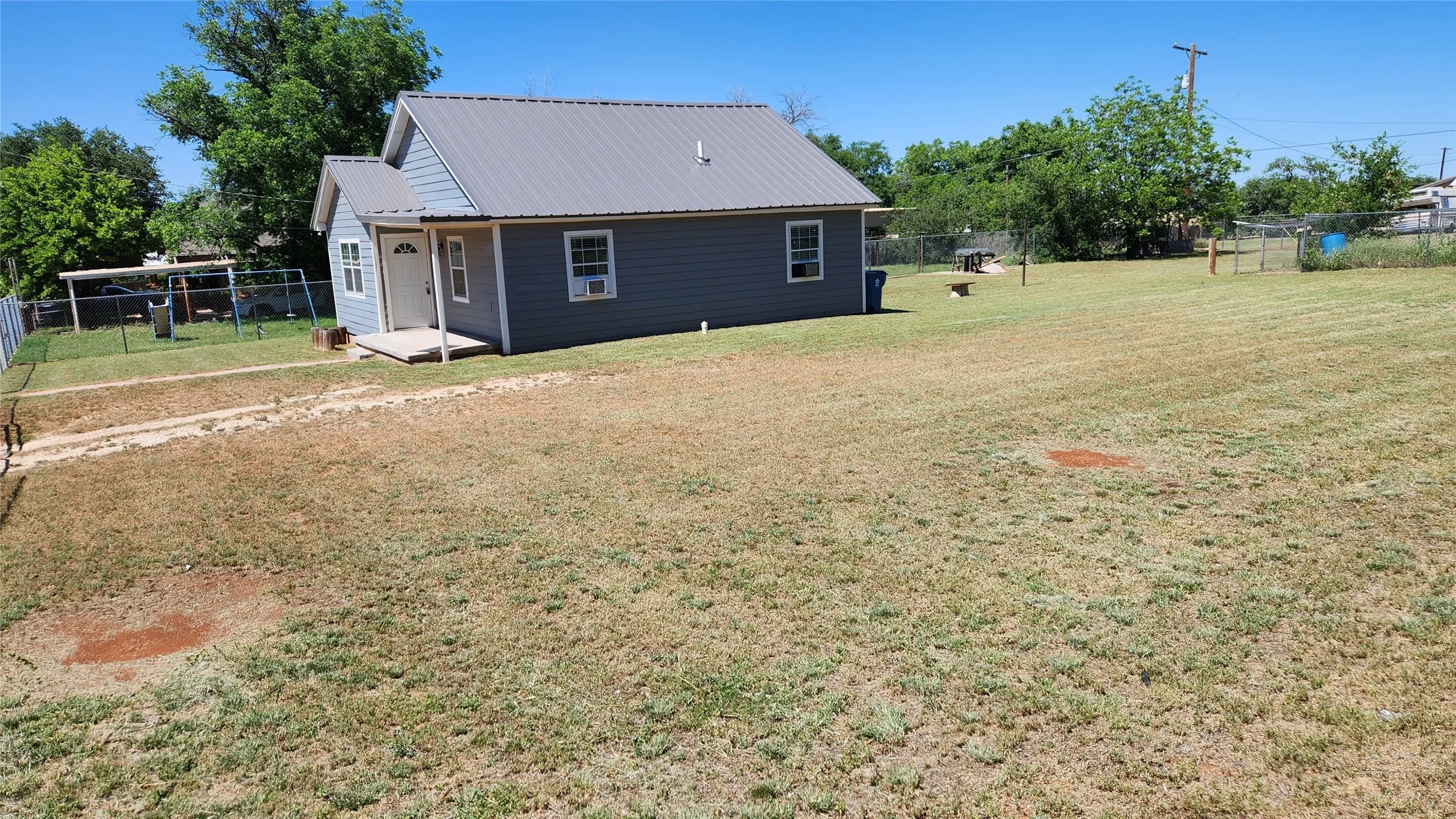 Back of property featuring metal roof