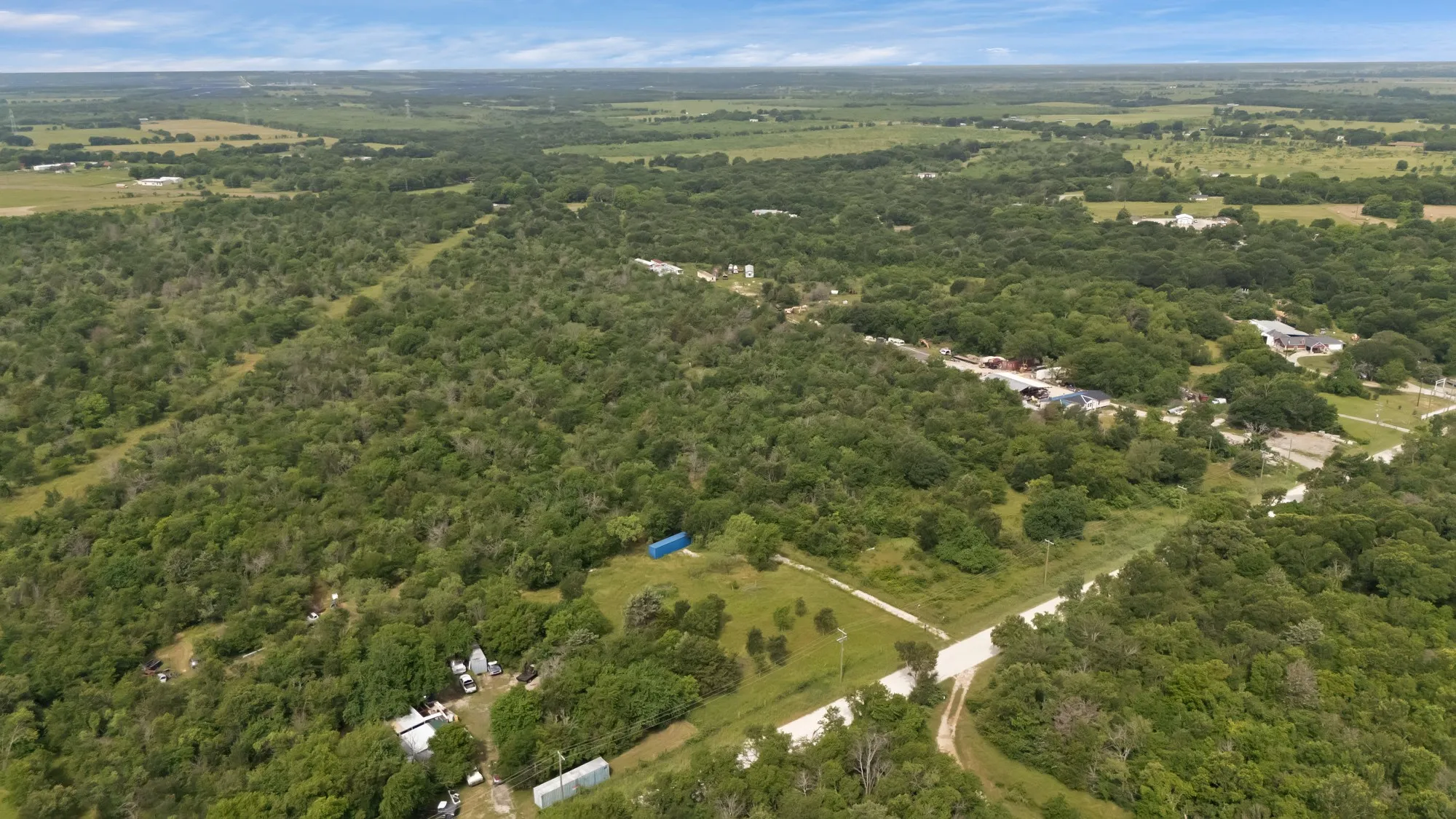 View of property location featuring a heavily wooded area