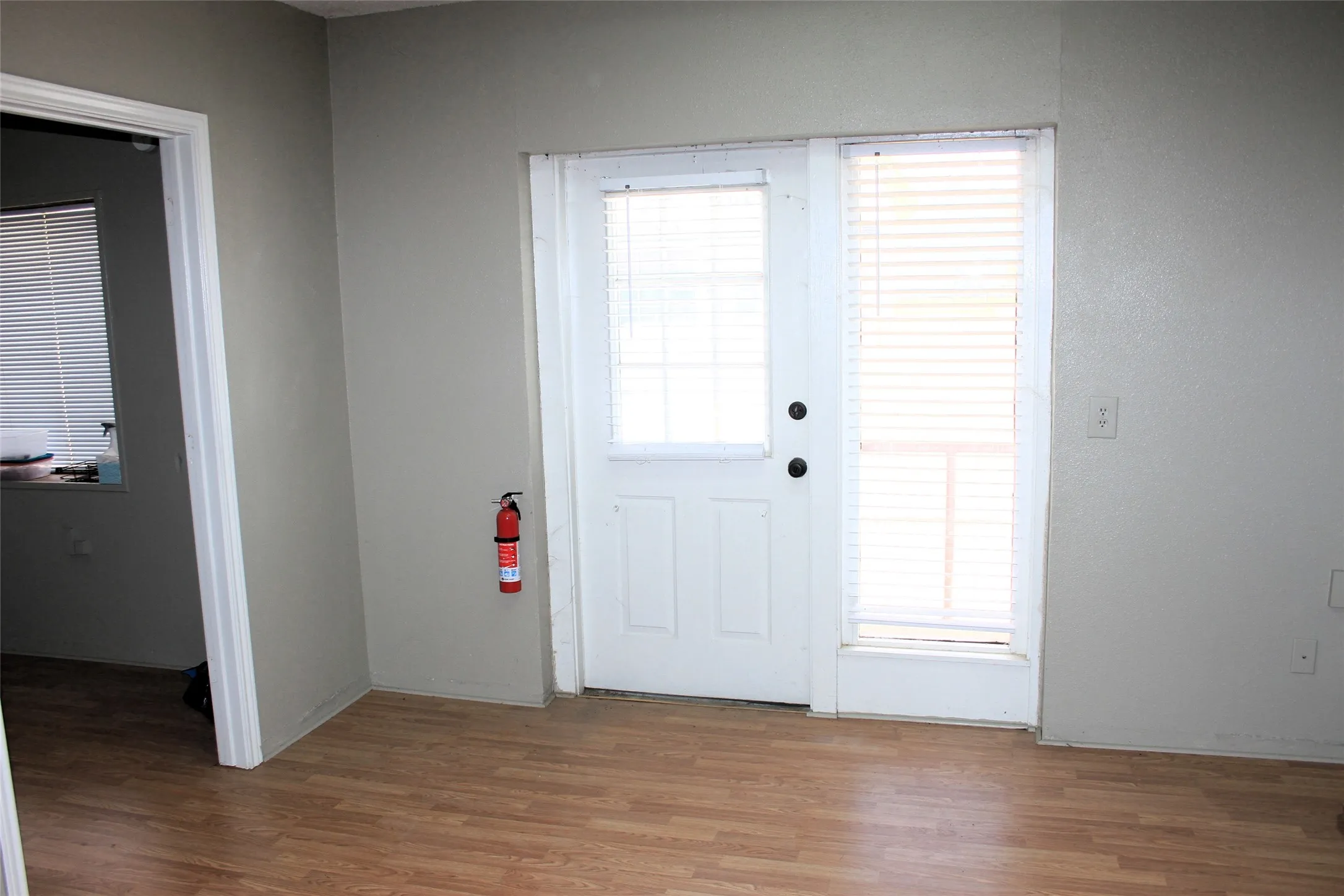 Doorway to outside with light wood-style flooring