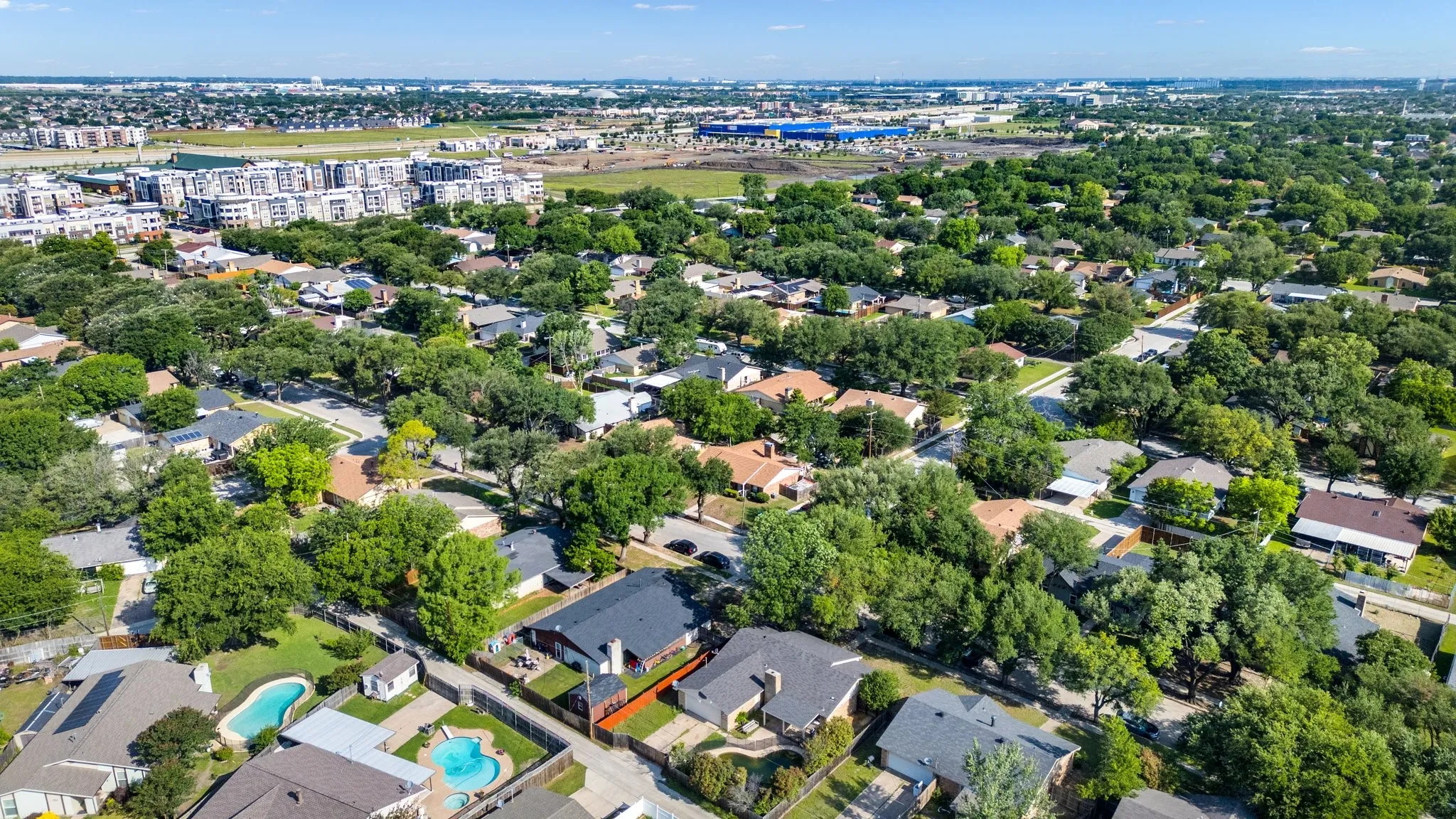 Aerial view of property and surrounding area with a pool area