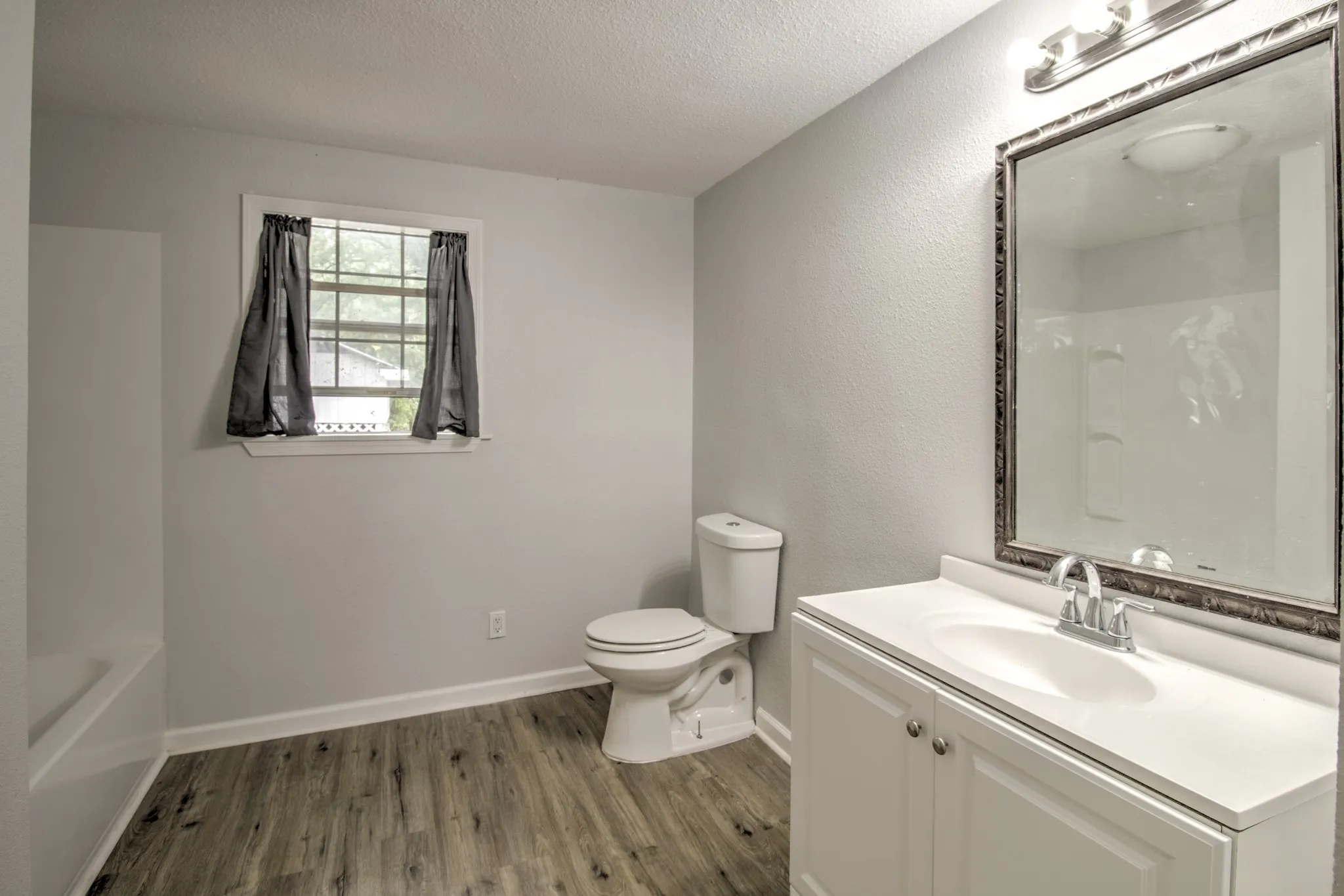 Bathroom with a vanity and step in tub/shower