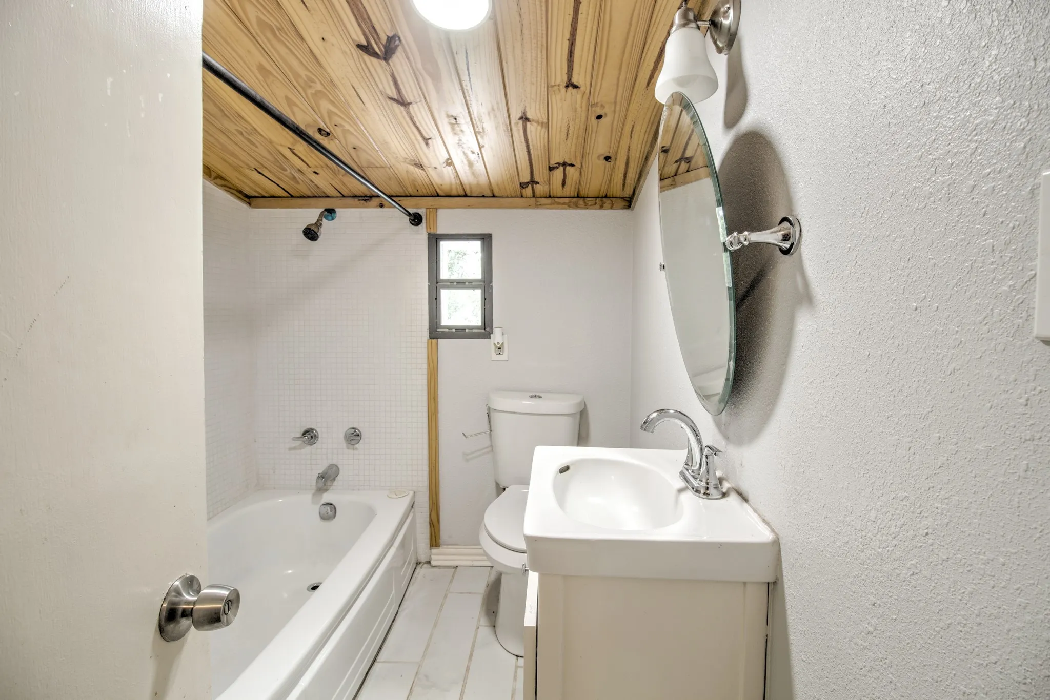 Bathroom featuring wooden ceiling, toilet, bathtub / shower combination, and vanity