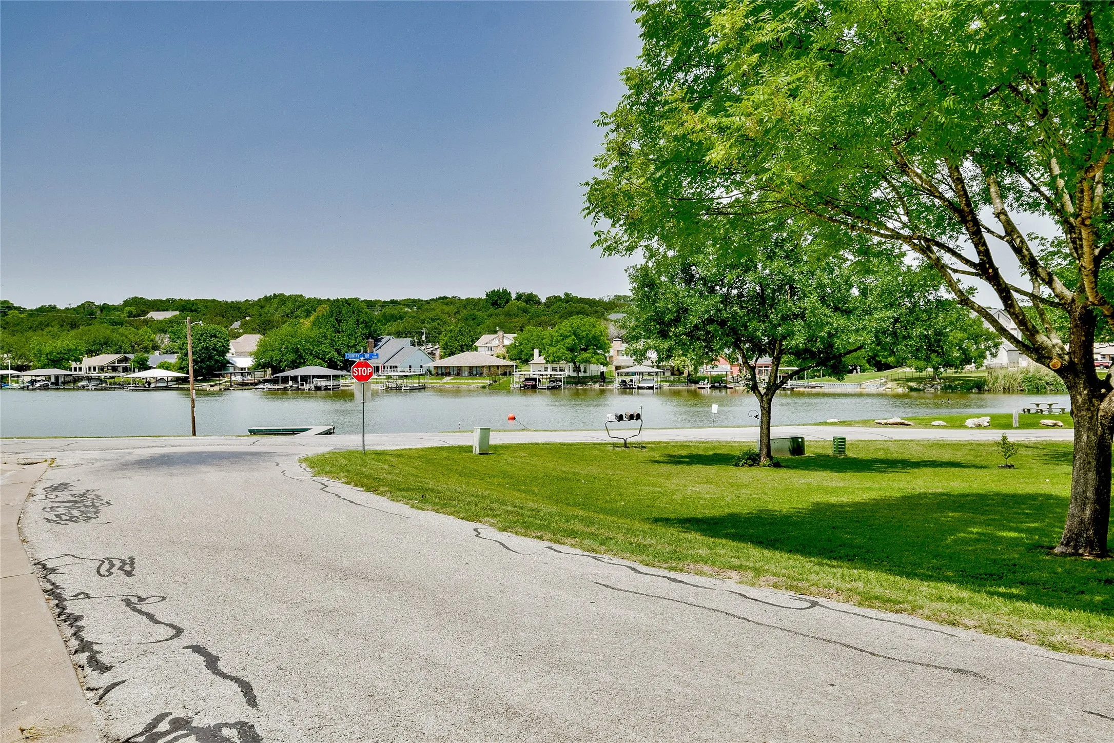 View of asphalt street featuring traffic signs and a water view