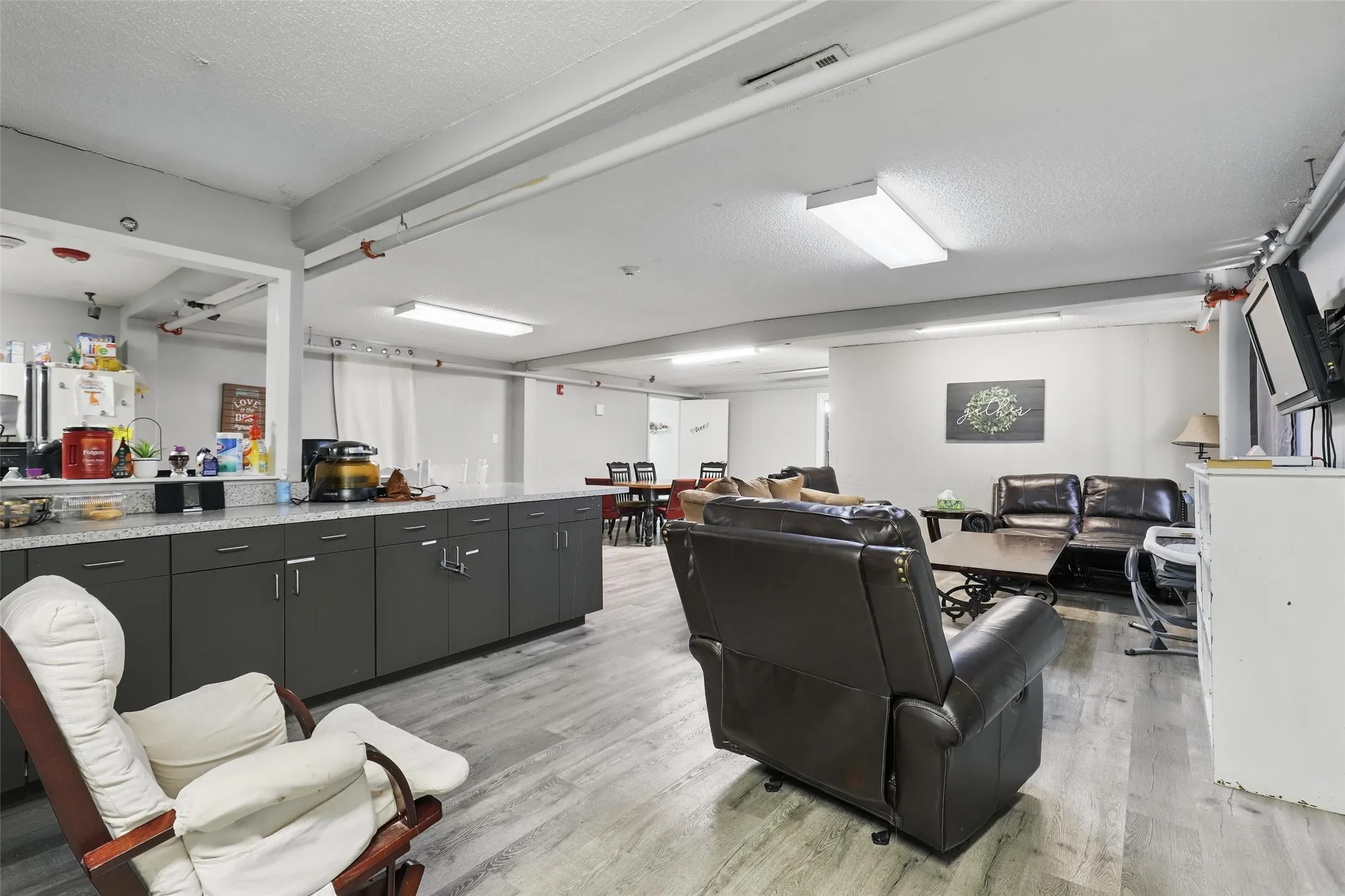 Living room featuring light wood-style flooring and a textured ceiling