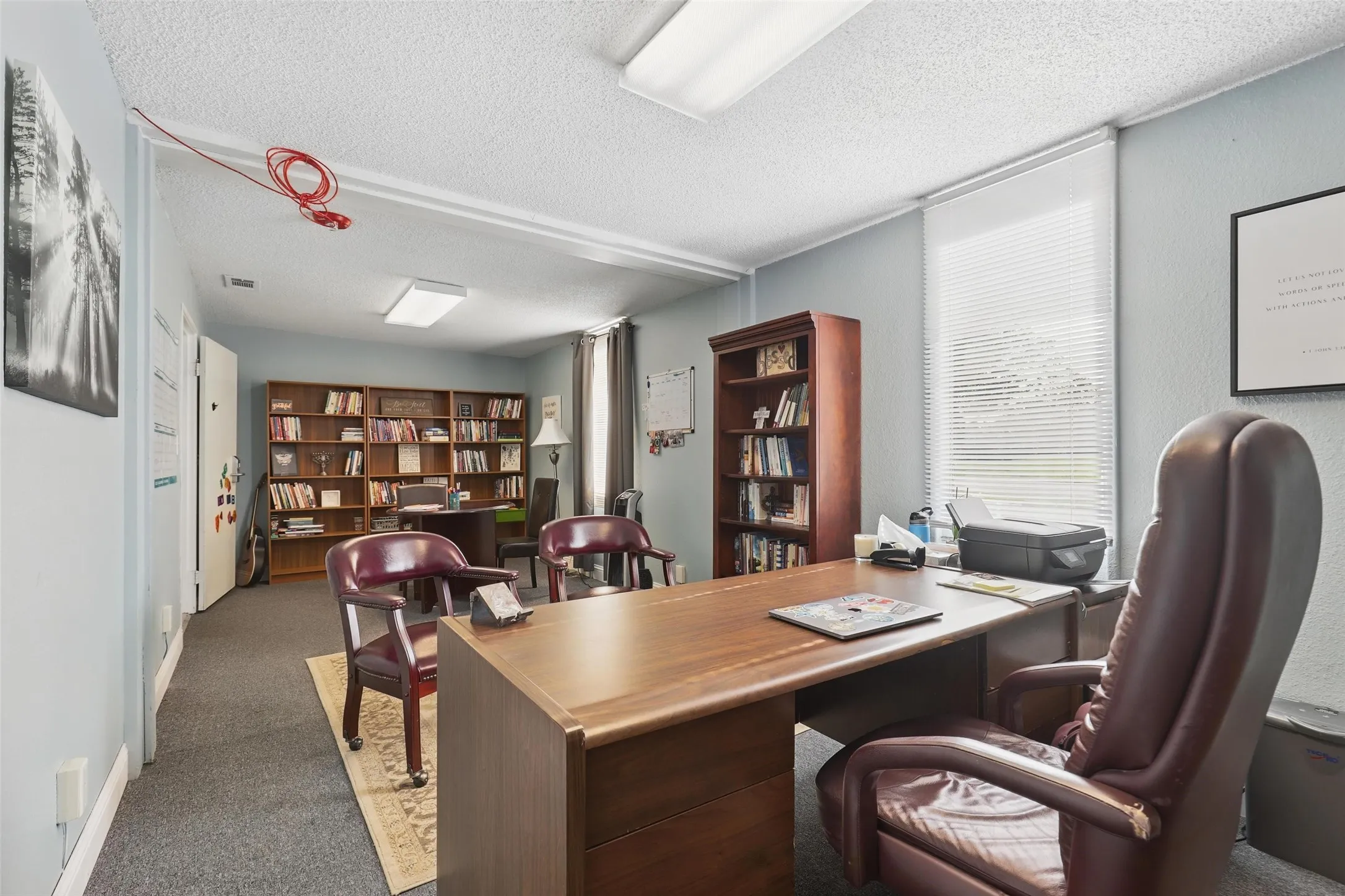Carpeted office space featuring a textured​​‌​​​​‌​​‌‌​‌‌​​​‌‌​‌​‌​‌​​​‌​​ ceiling