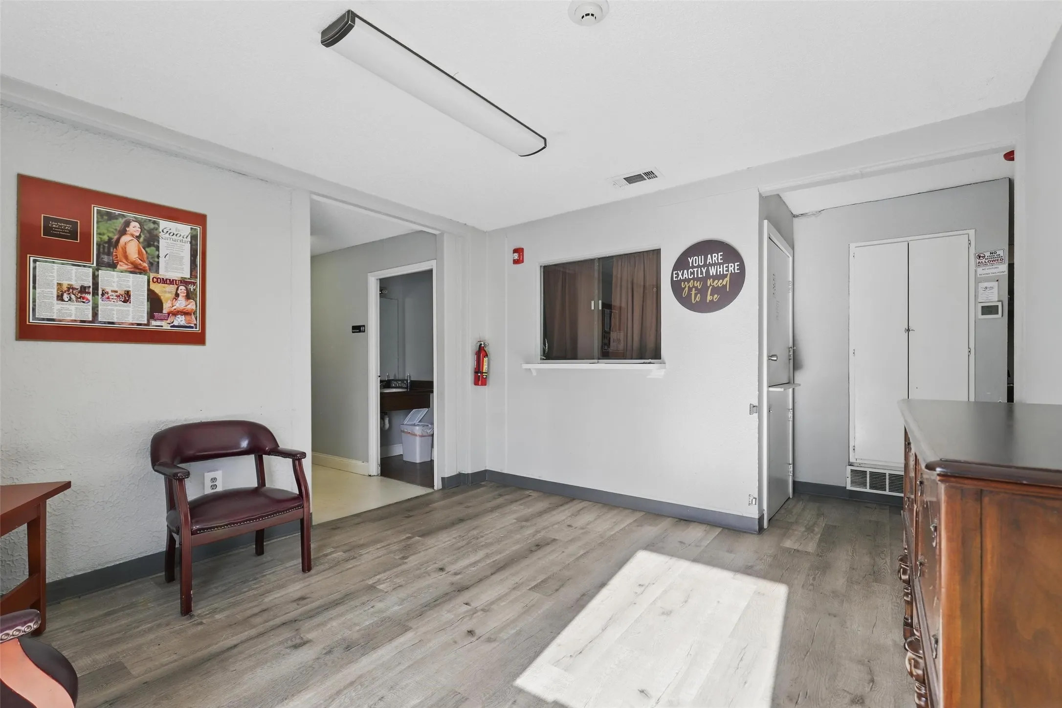 Living area with light wood finished floors and baseboards