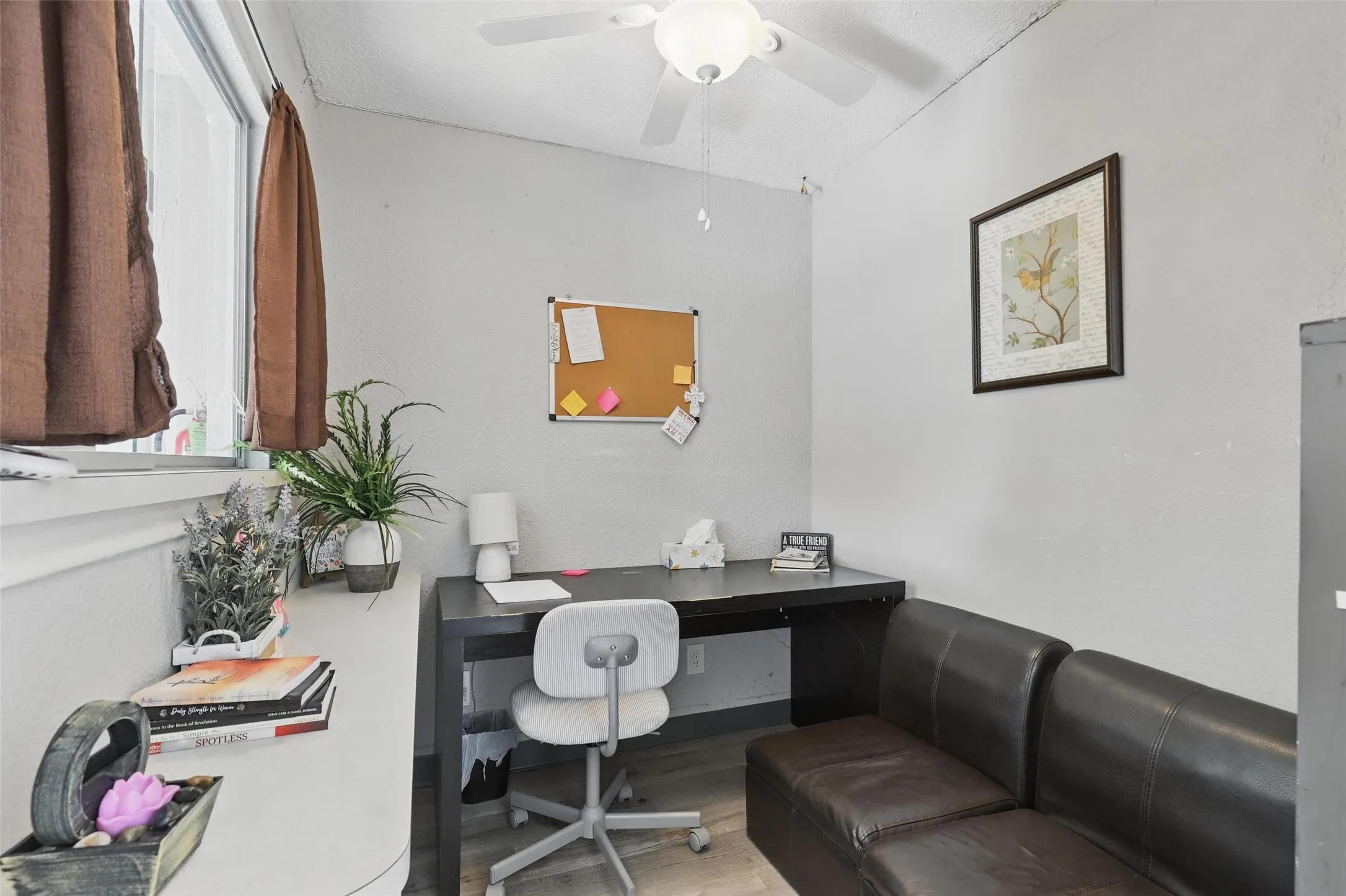 Home office featuring wood finished floors and ceiling fan