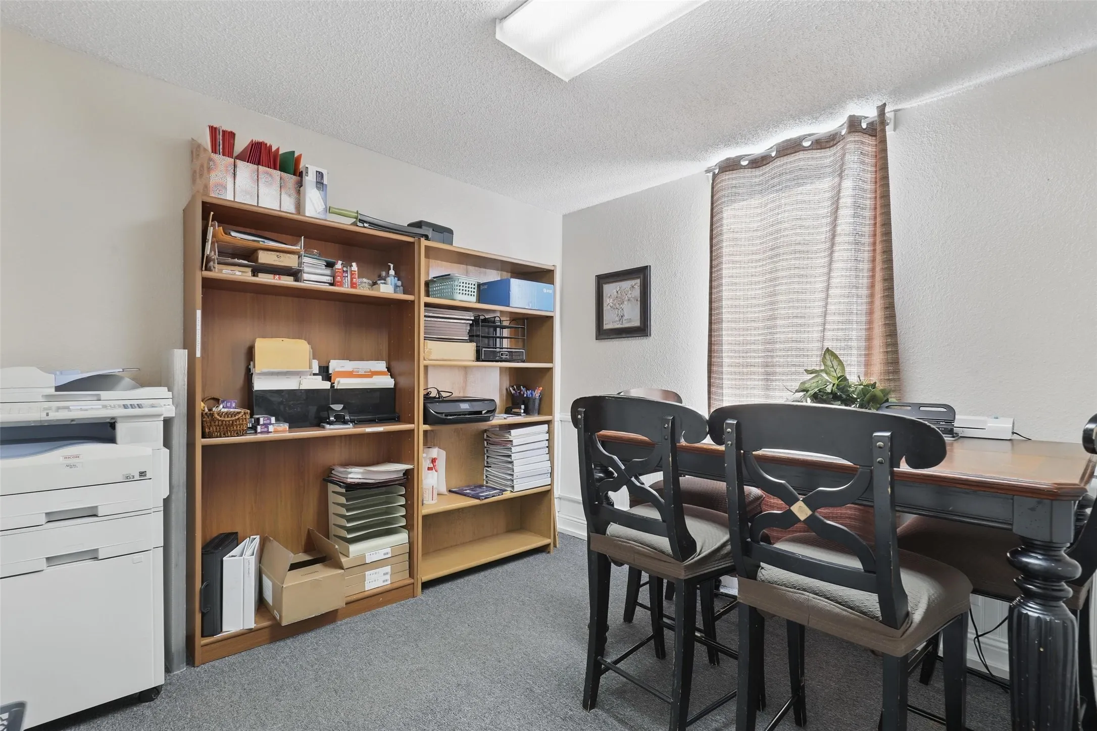 Office featuring a textured ceiling and carpet floors