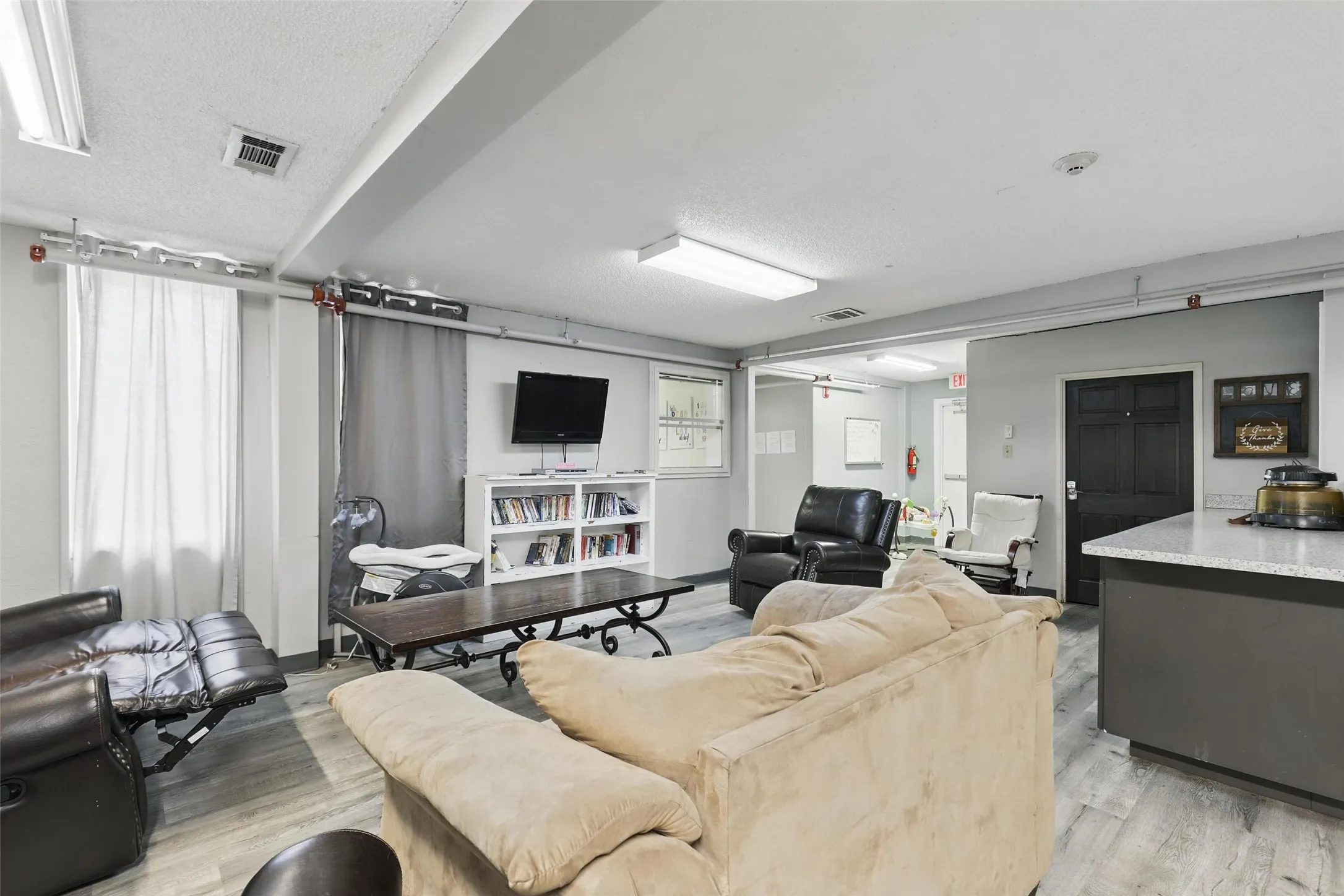 Living room featuring light wood-type flooring and a textured ceiling
