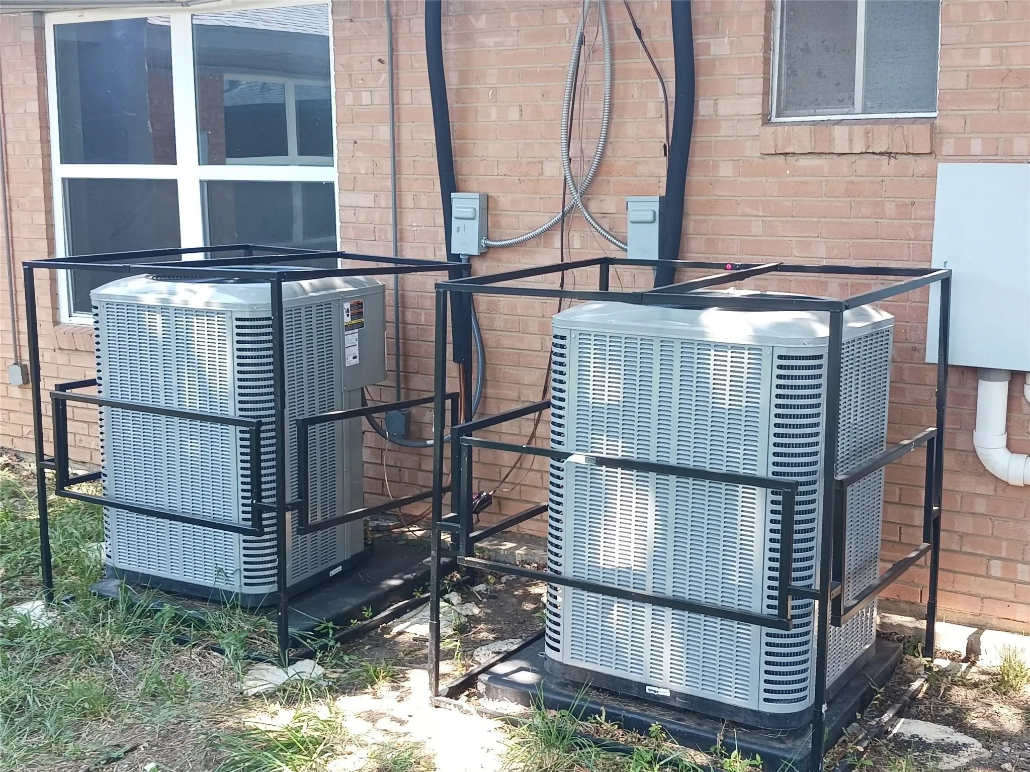 Exterior view of cooling unit and brick siding