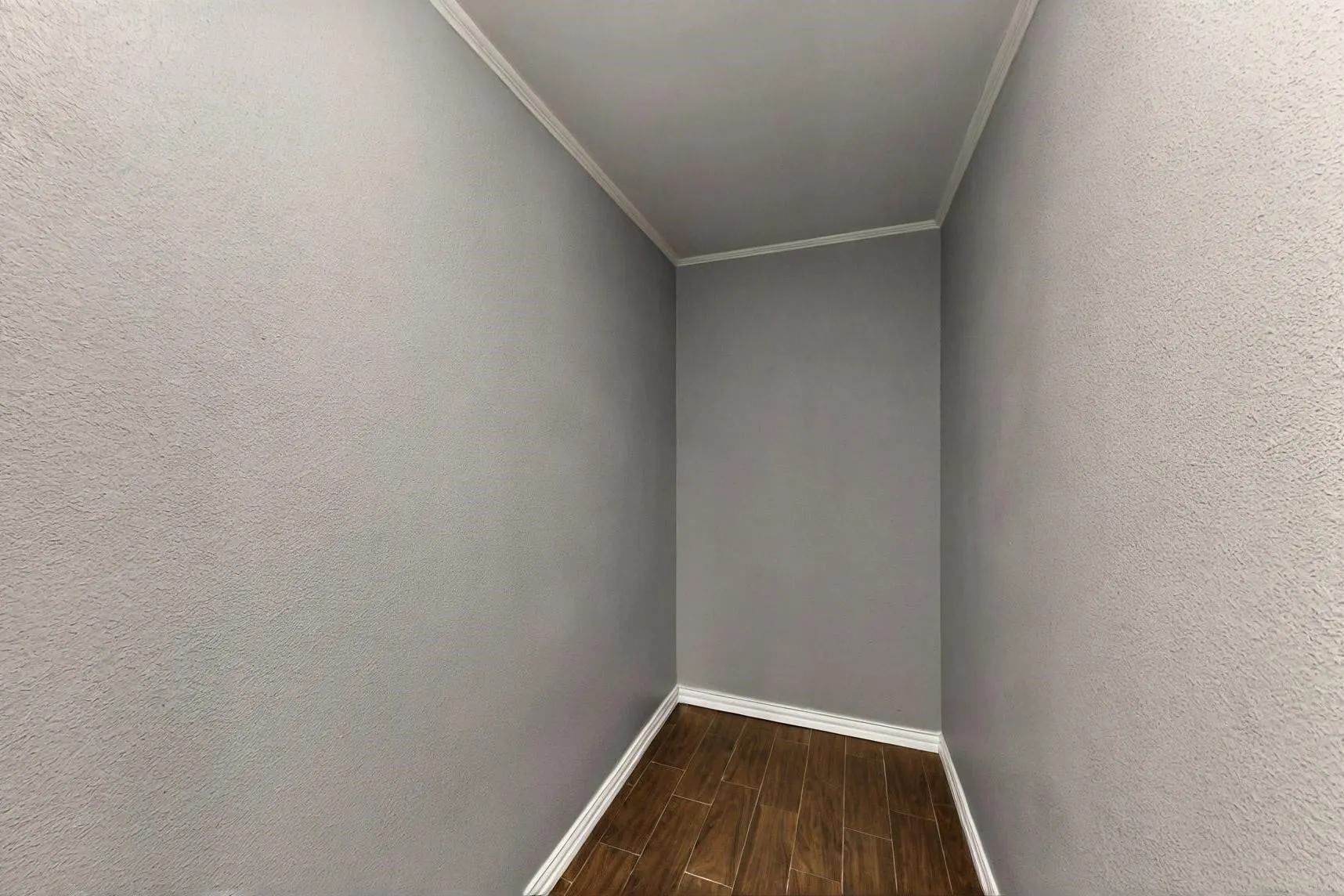 Unfurnished room with baseboards, wood finish floors, and crown molding