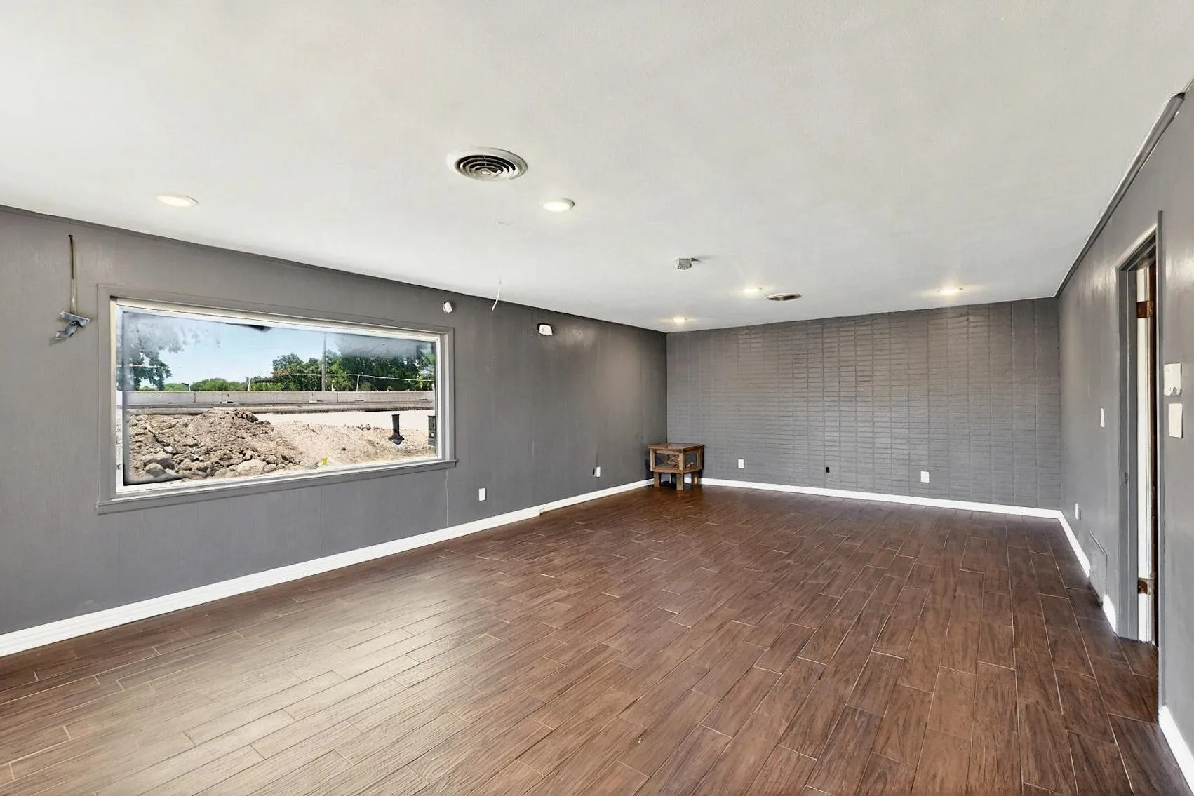 Empty room featuring wood finished floors and baseboards