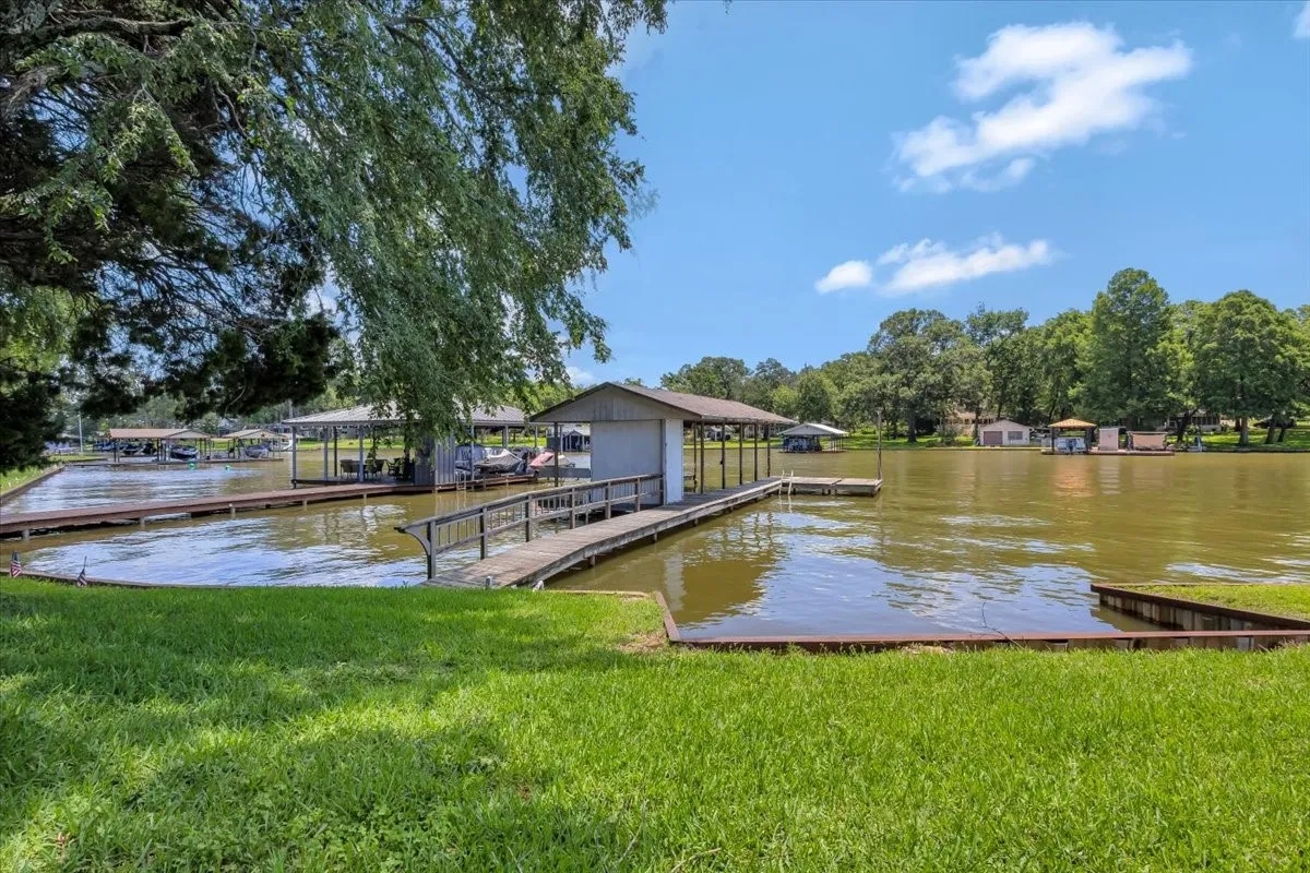 Dock featuring a water view and a yard