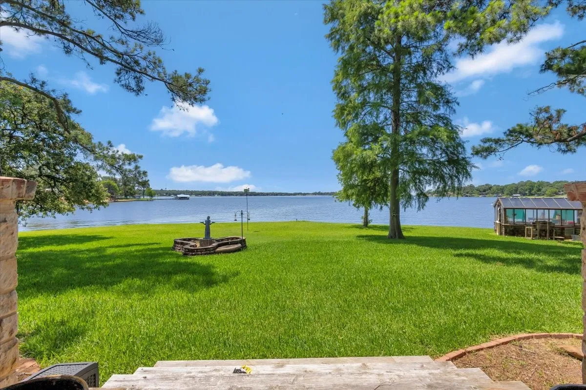 View of grassy yard with a water view