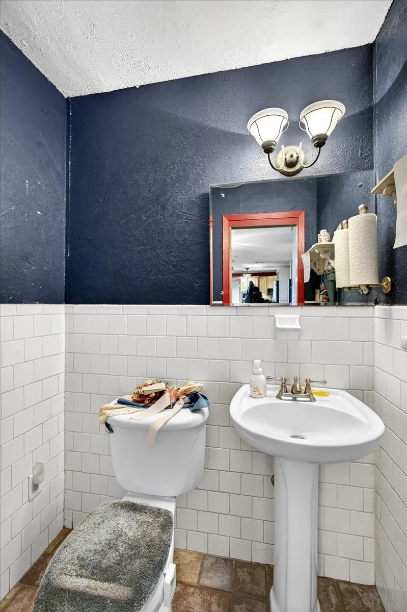 Bathroom with tile walls and wainscoting
