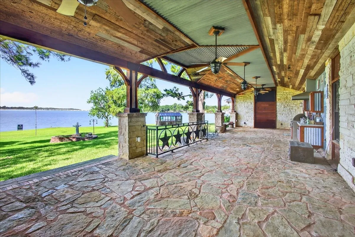 View of patio / terrace with a ceiling fan and a water view