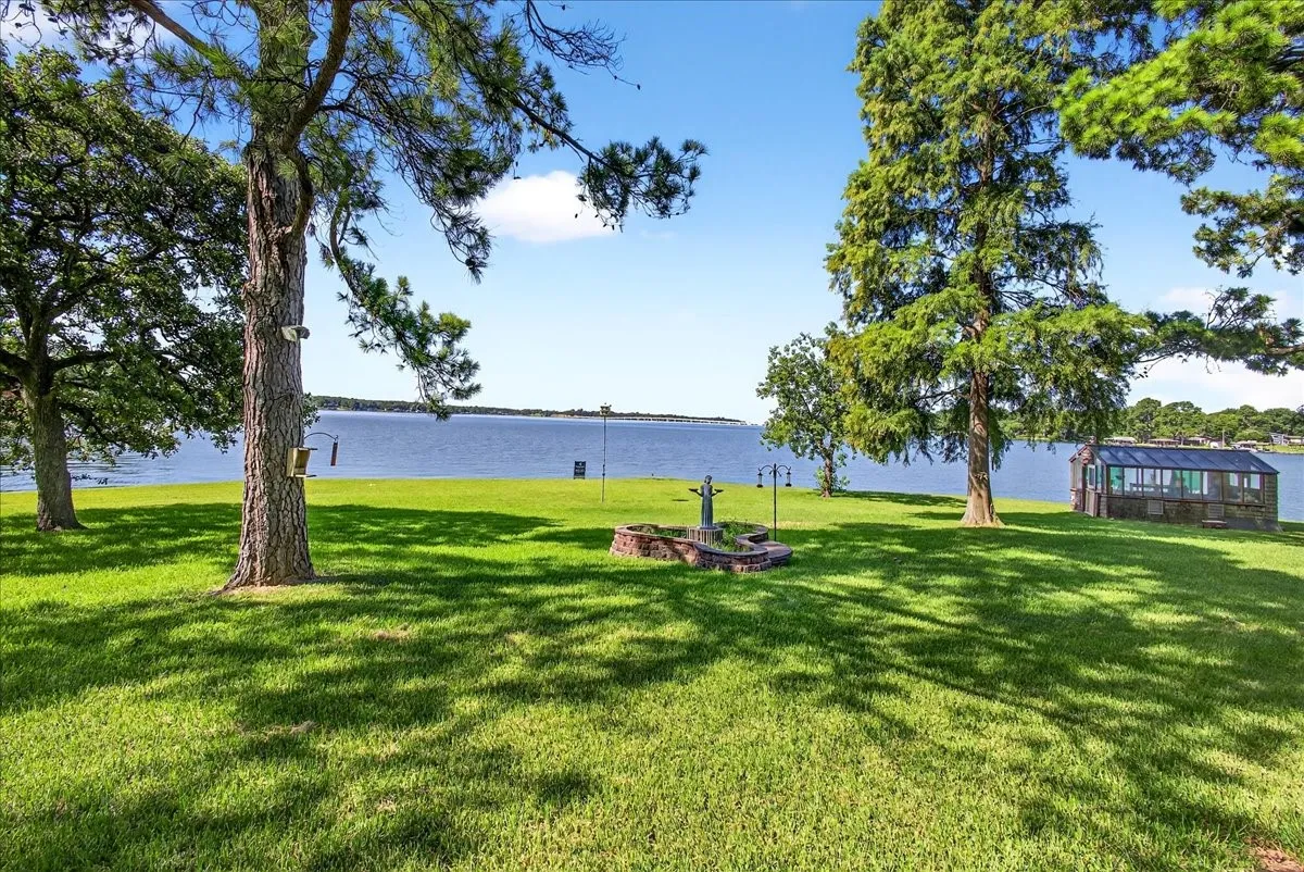 View of grassy yard with a water view