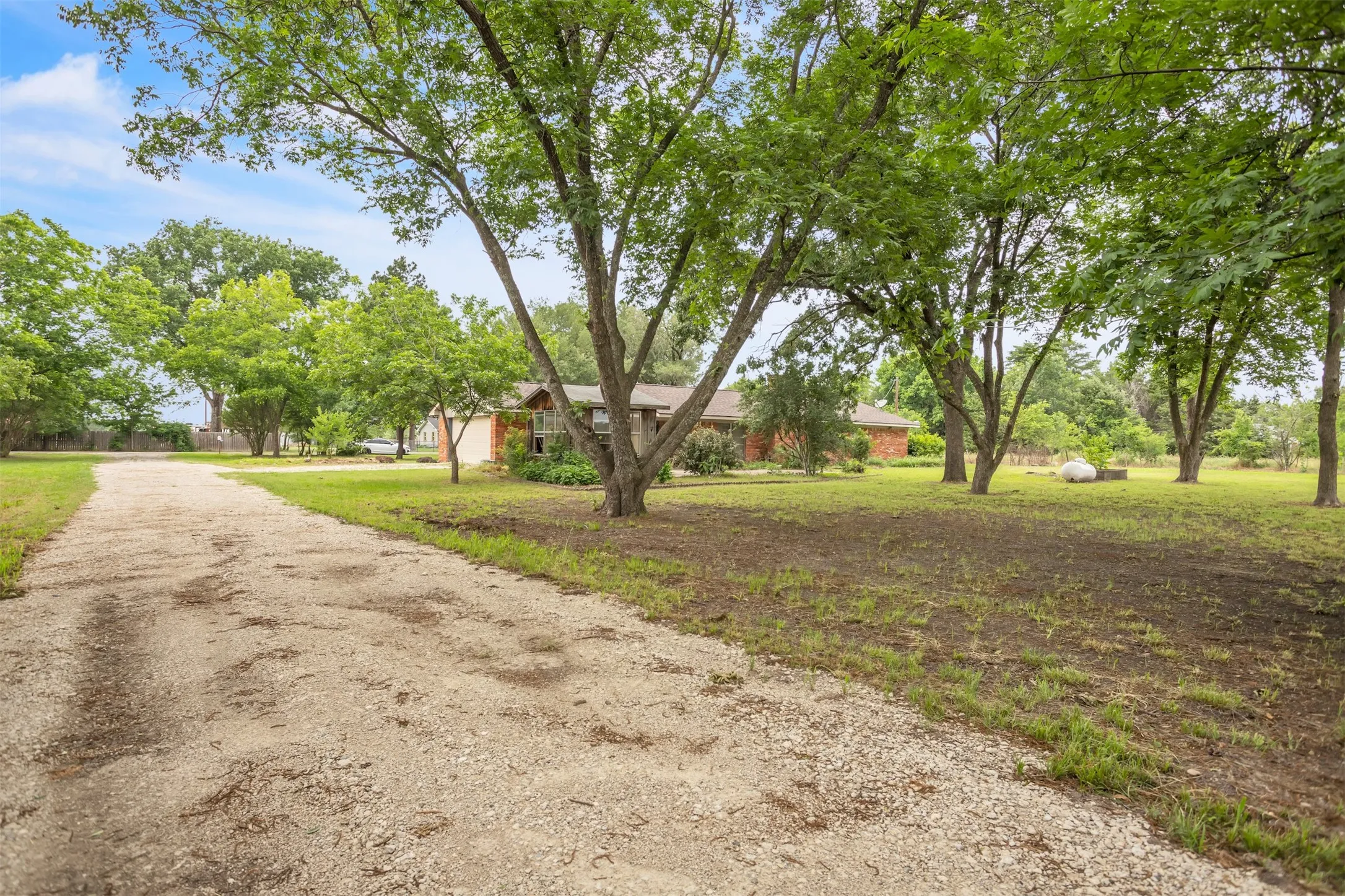 View of front of home with driveway and a front yard