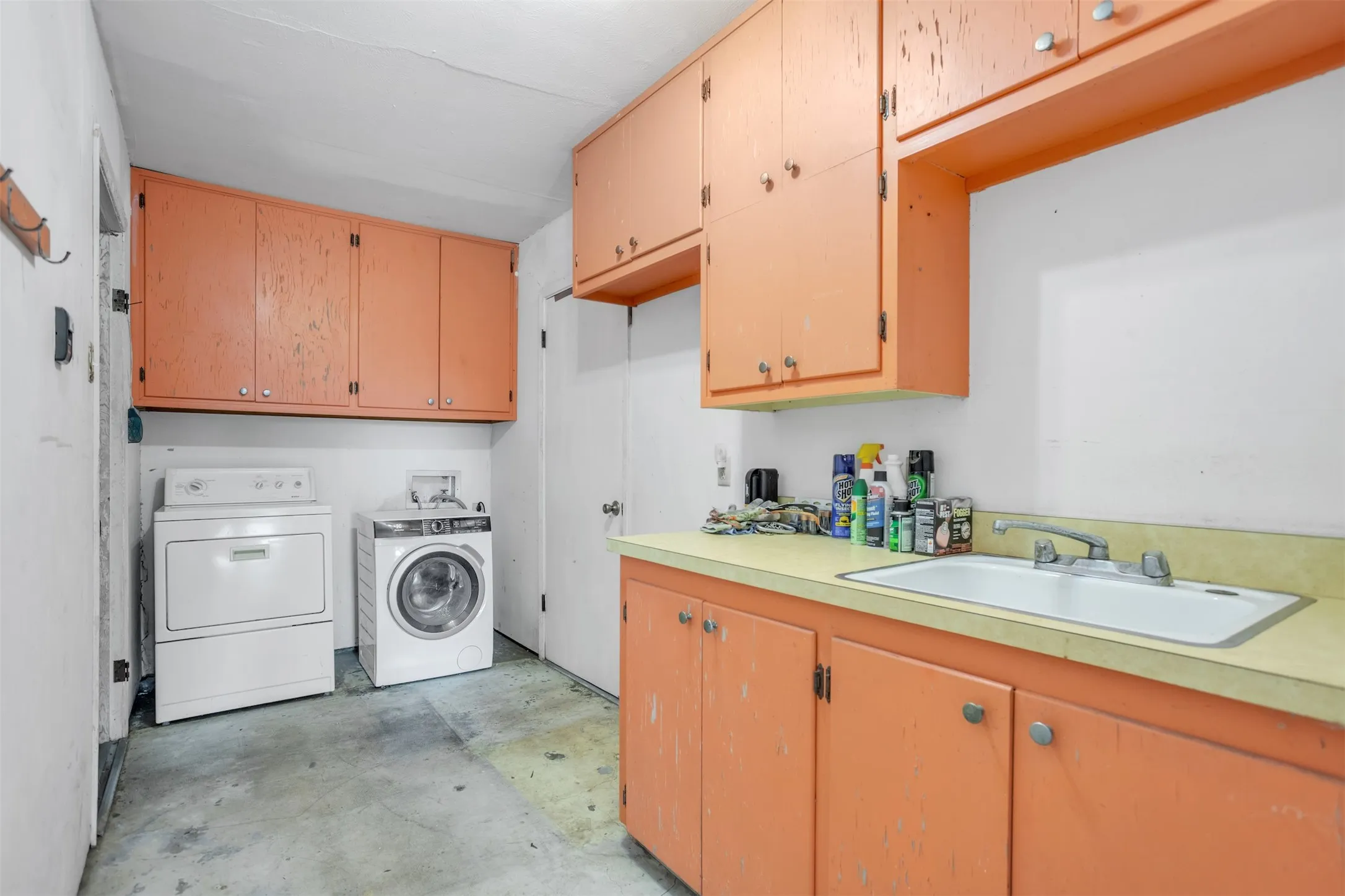 Laundry area featuring cabinet space and washer and clothes dryer