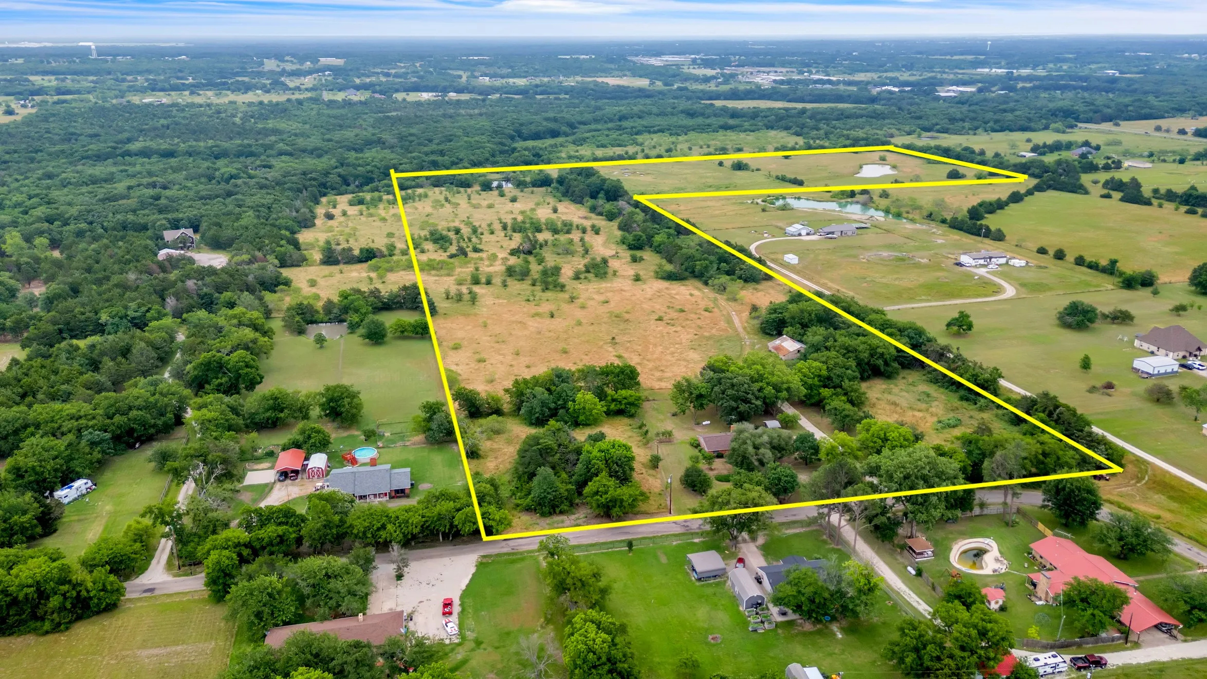 Aerial view of property's location featuring property parcel outlined 68 acres