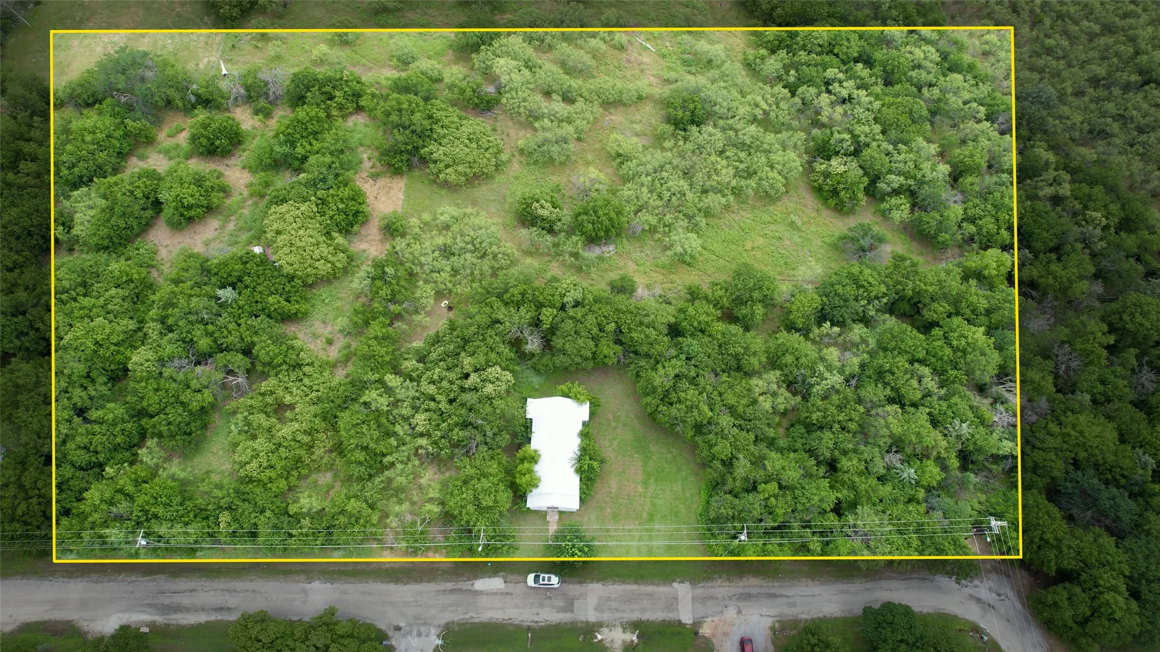 Aerial view of property and surrounding area featuring property boundaries highlighted
