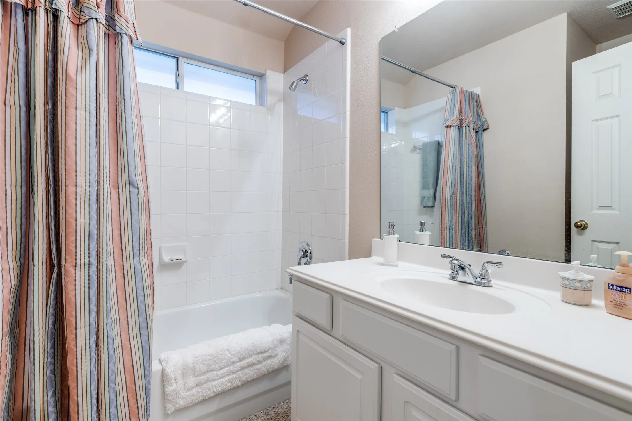 Your secondary bath provides a tub/shower.  Storage below the sink area.