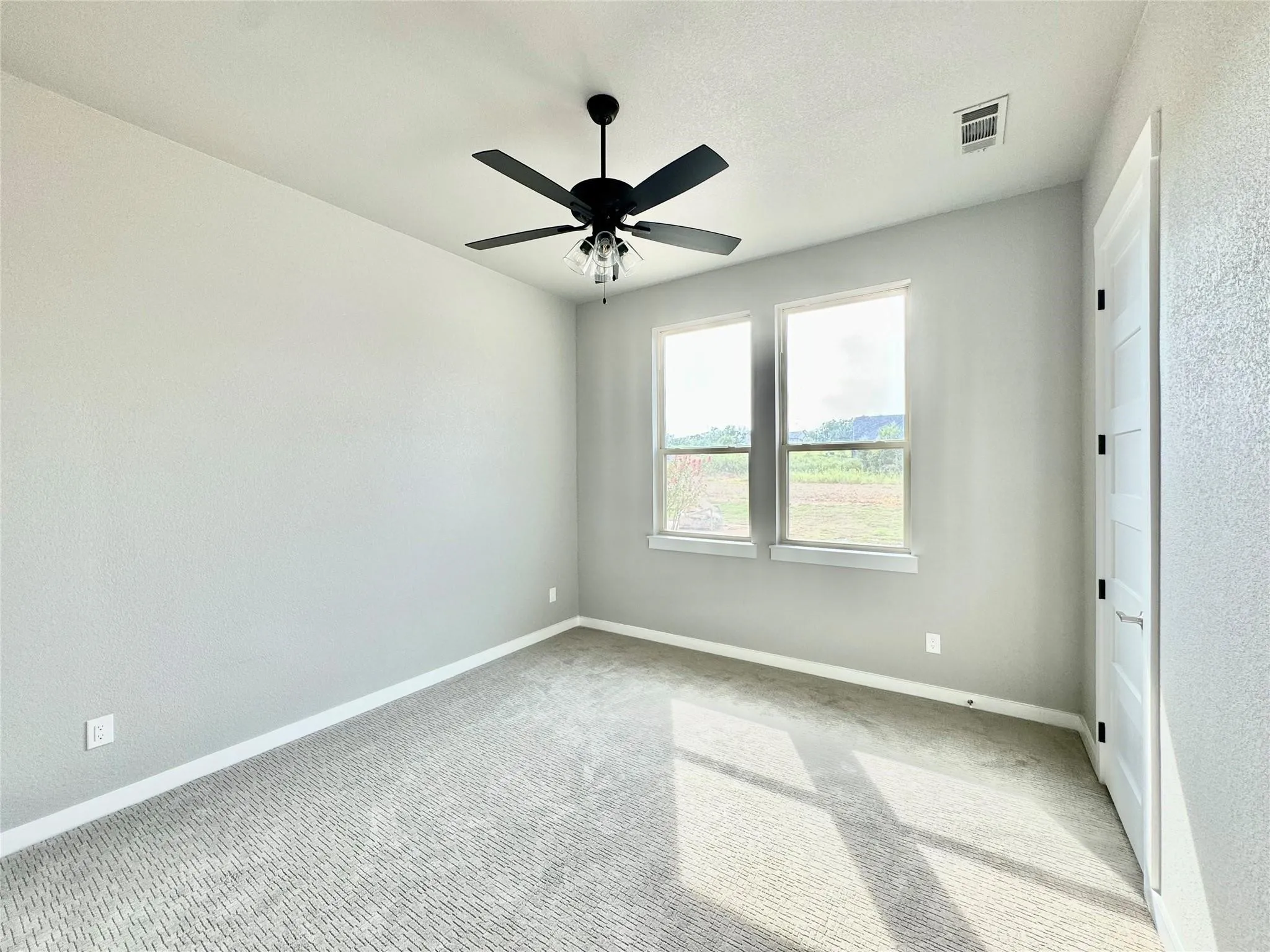 Unfurnished bedroom with baseboards, carpet flooring, and a ceiling fan