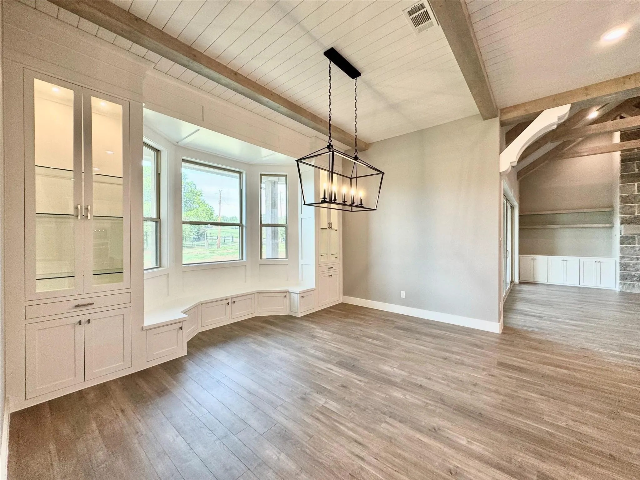 Unfurnished dining area with wood finished floors, a chandelier, baseboards, and wood ceiling