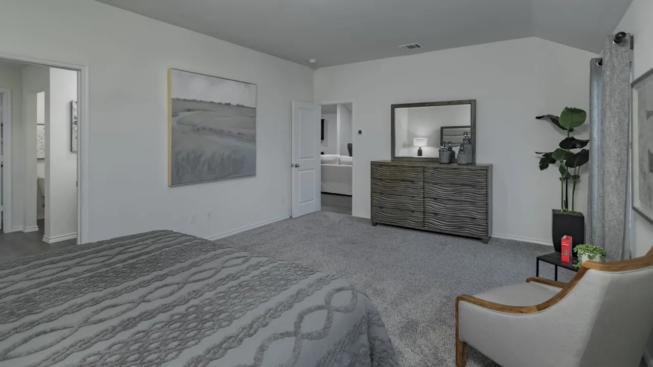 Bedroom with ensuite bath, light colored carpet, and lofted ceiling