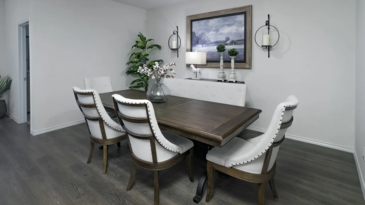 Dining area featuring dark wood-style flooring and baseboards