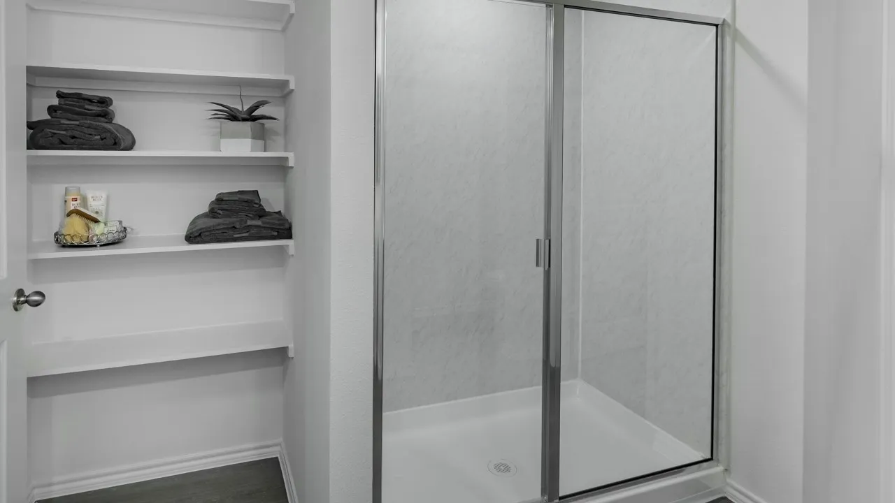 Full bathroom featuring a shower stall and a closet