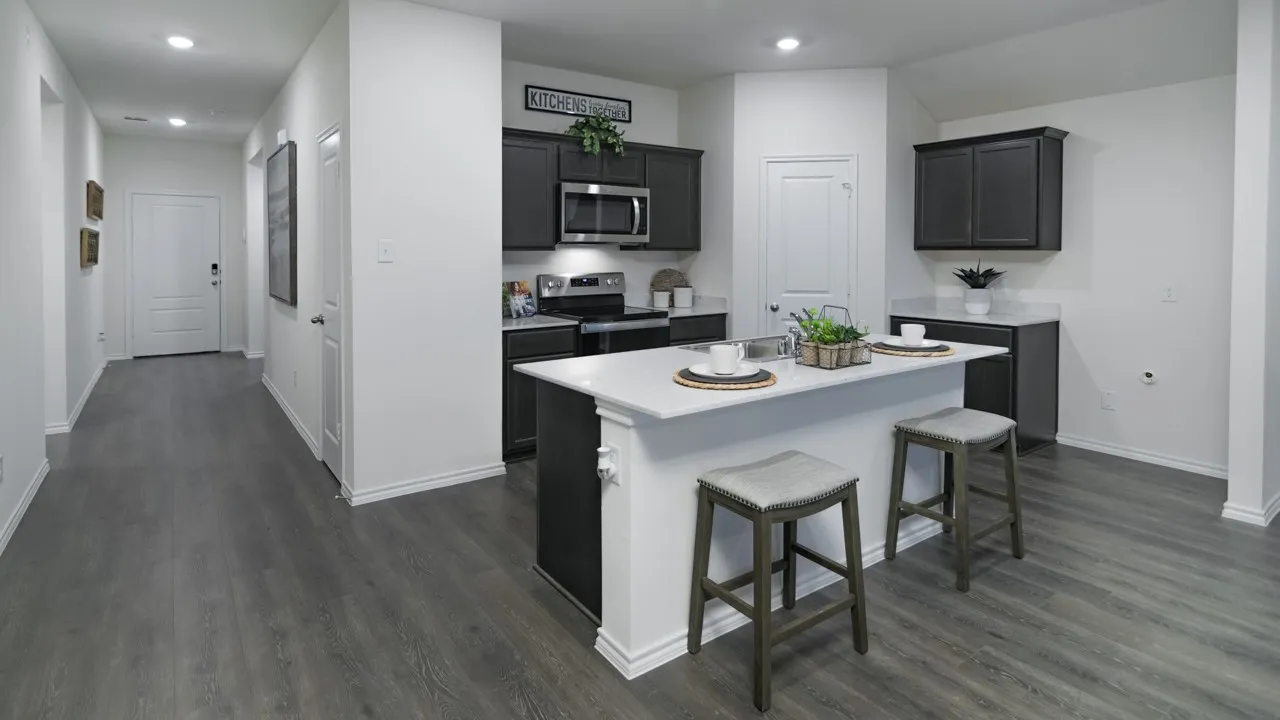 Kitchen featuring stainless steel appliances, a kitchen island with sink, a breakfast bar, dark wood-type flooring, and recessed lighting