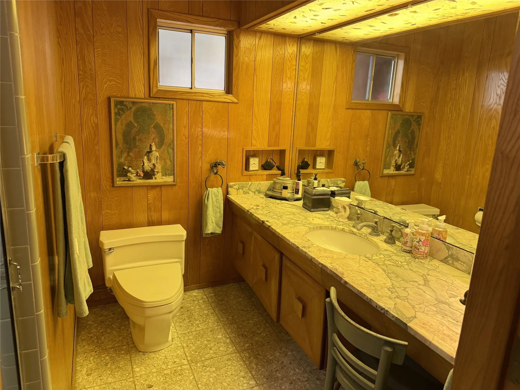 Full bathroom featuring vanity, light flooring, and wooden walls