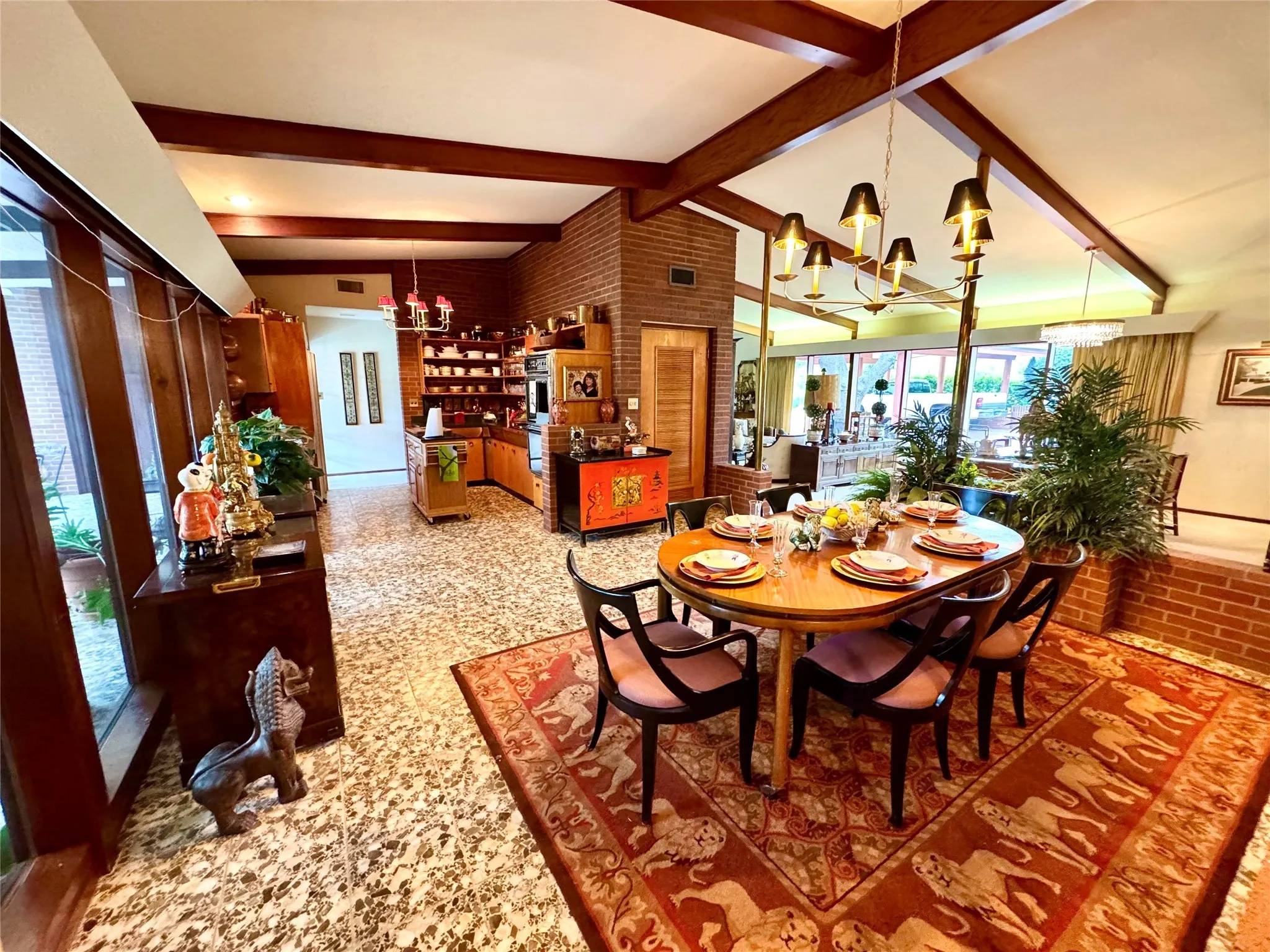 Dining space featuring a chandelier and brick wall