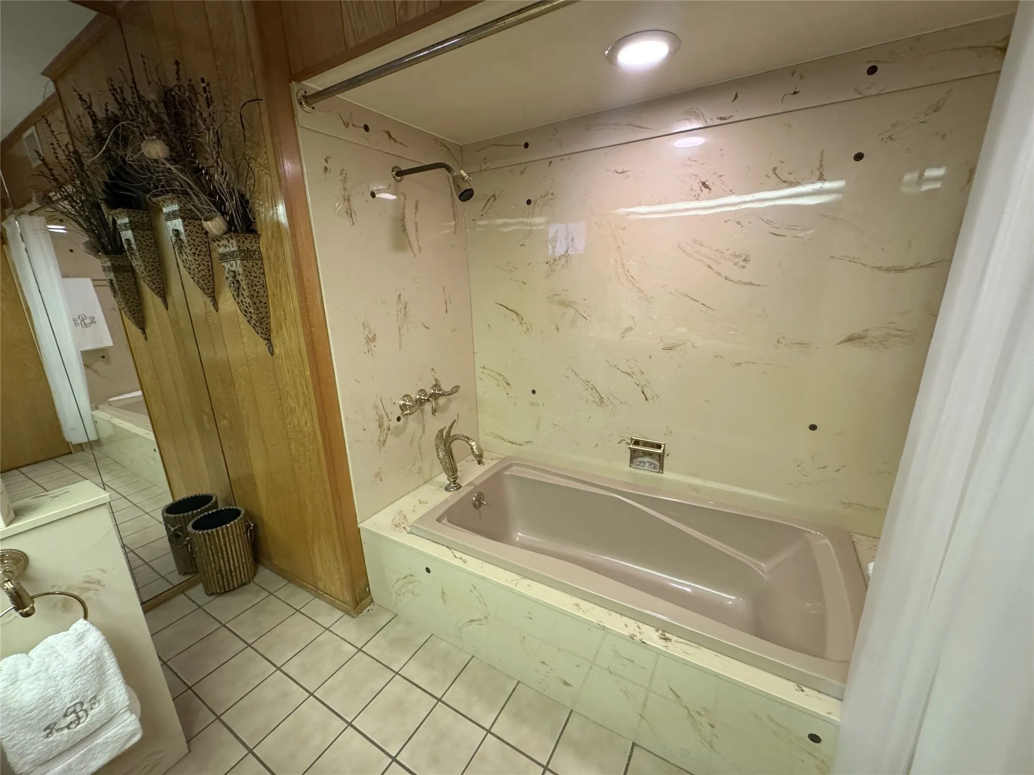 Full bathroom featuring light tile patterned floors and a combined bath / shower with marble appearance