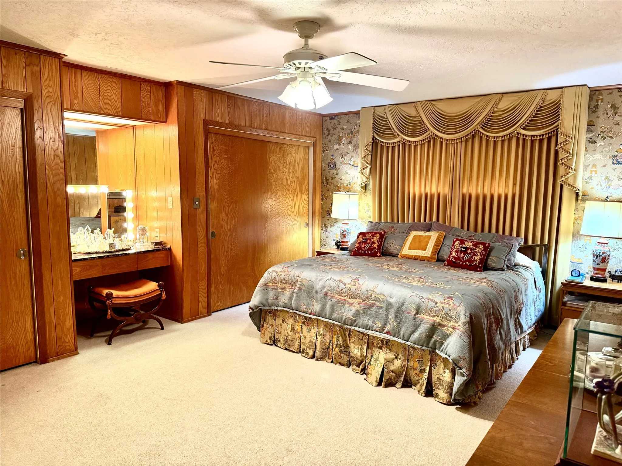 Carpeted bedroom featuring a closet, a textured ceiling, and ceiling fan