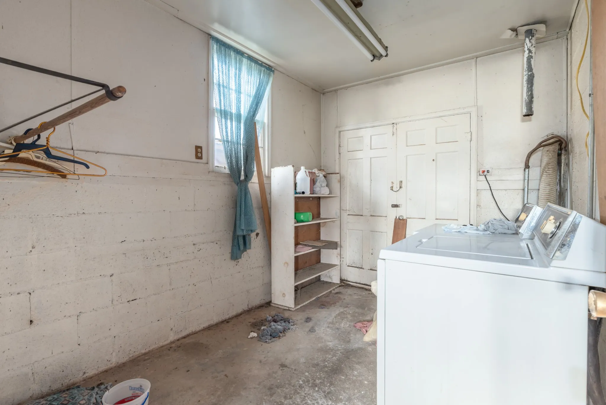 Laundry room featuring washer / clothes dryer and concrete flooring