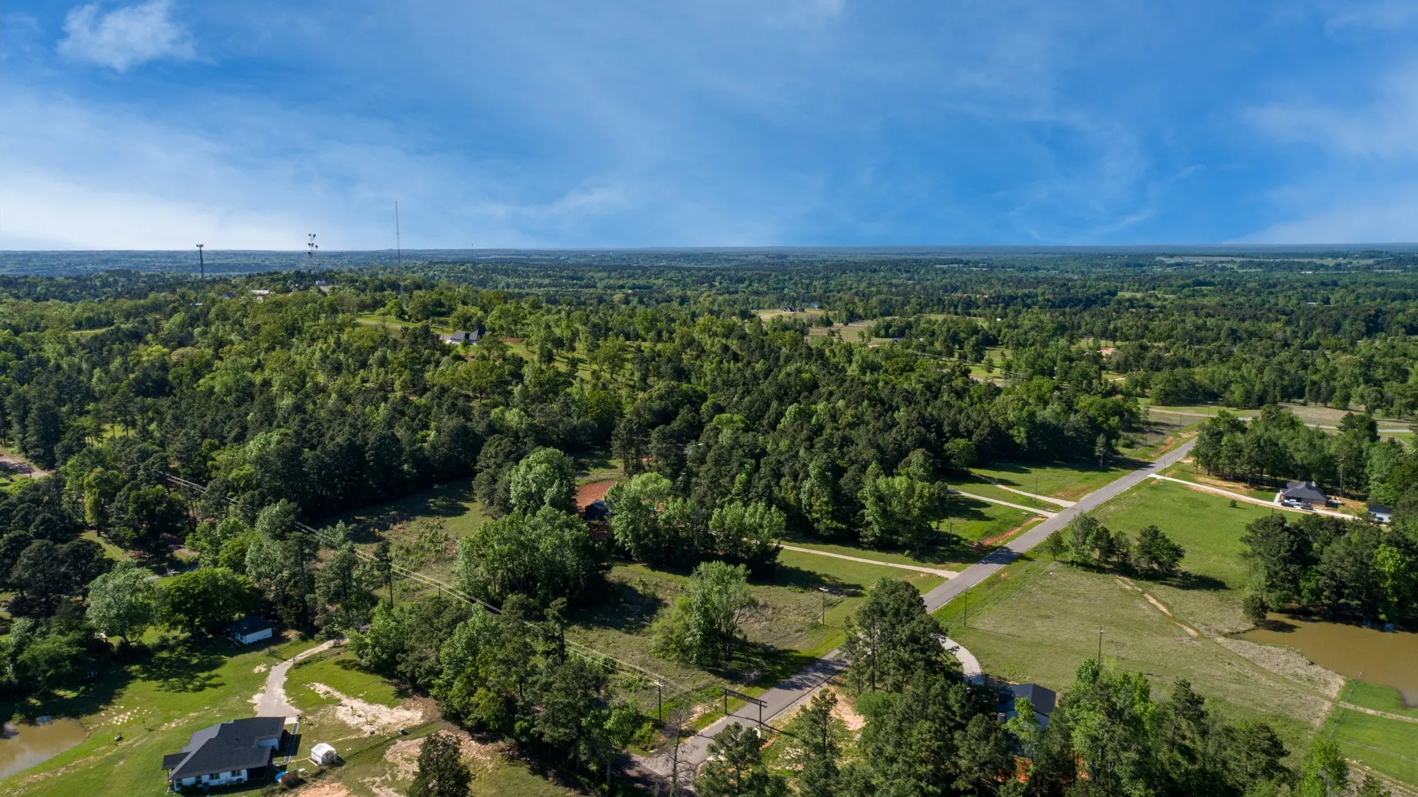 Drone / aerial view with a wooded view