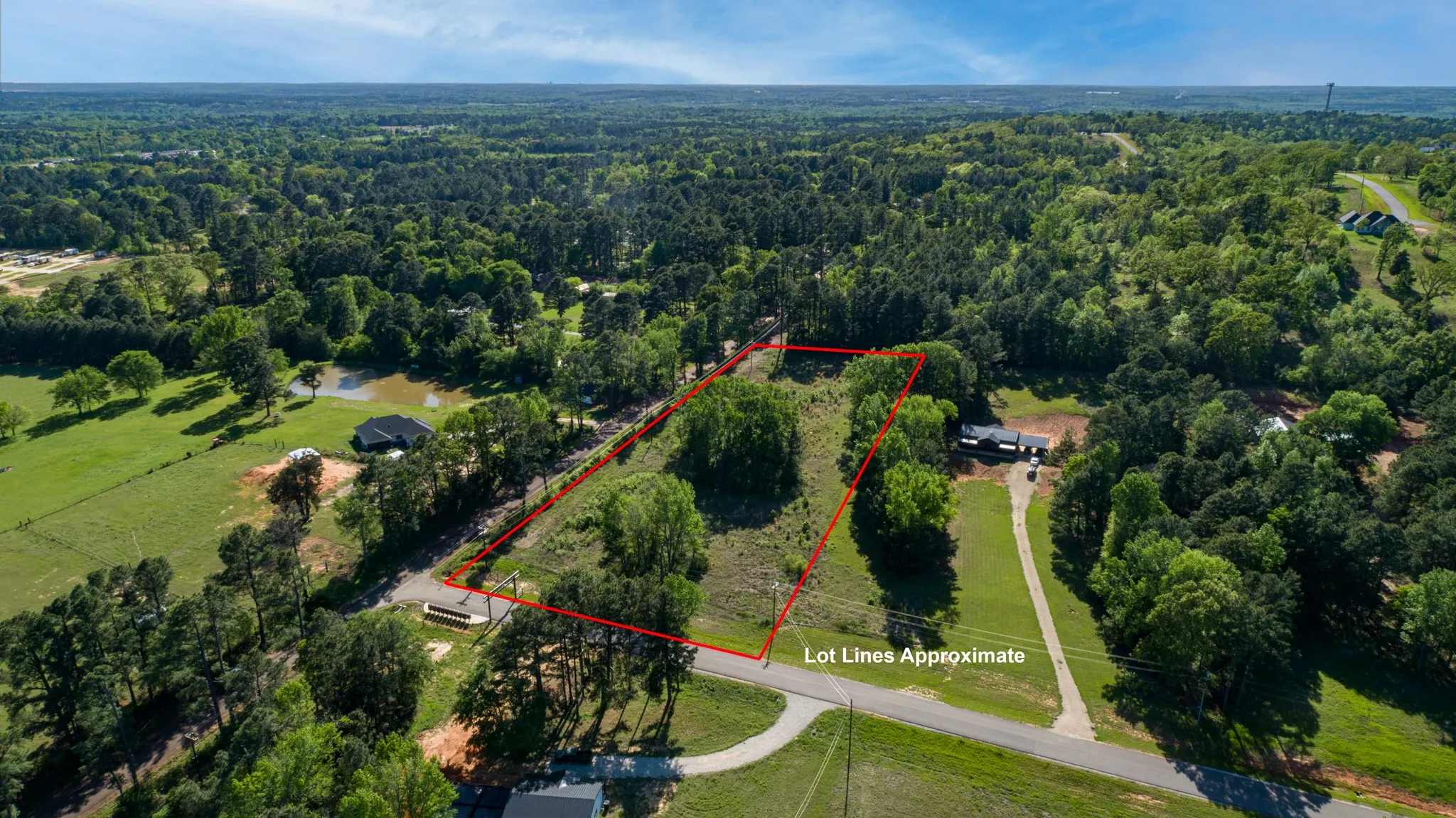 Aerial view featuring a wooded view