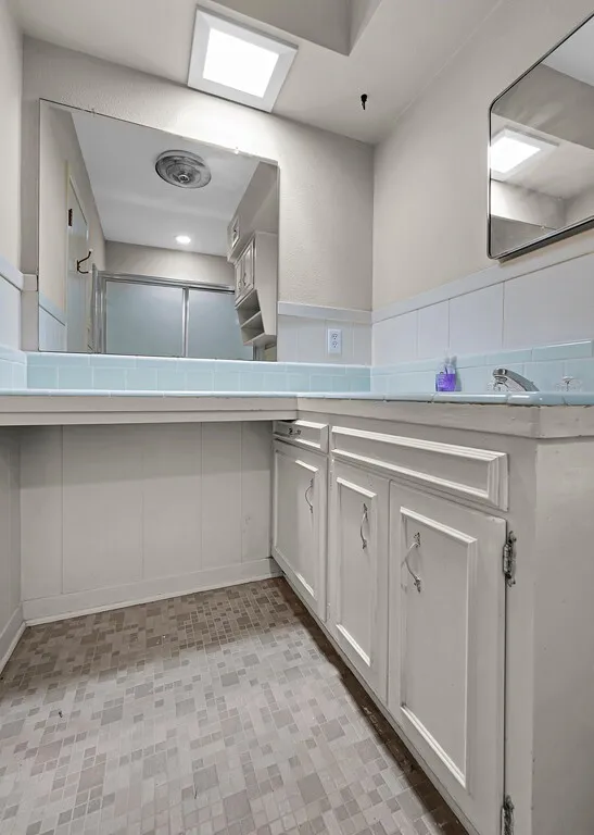 Full bath featuring vanity and a shower