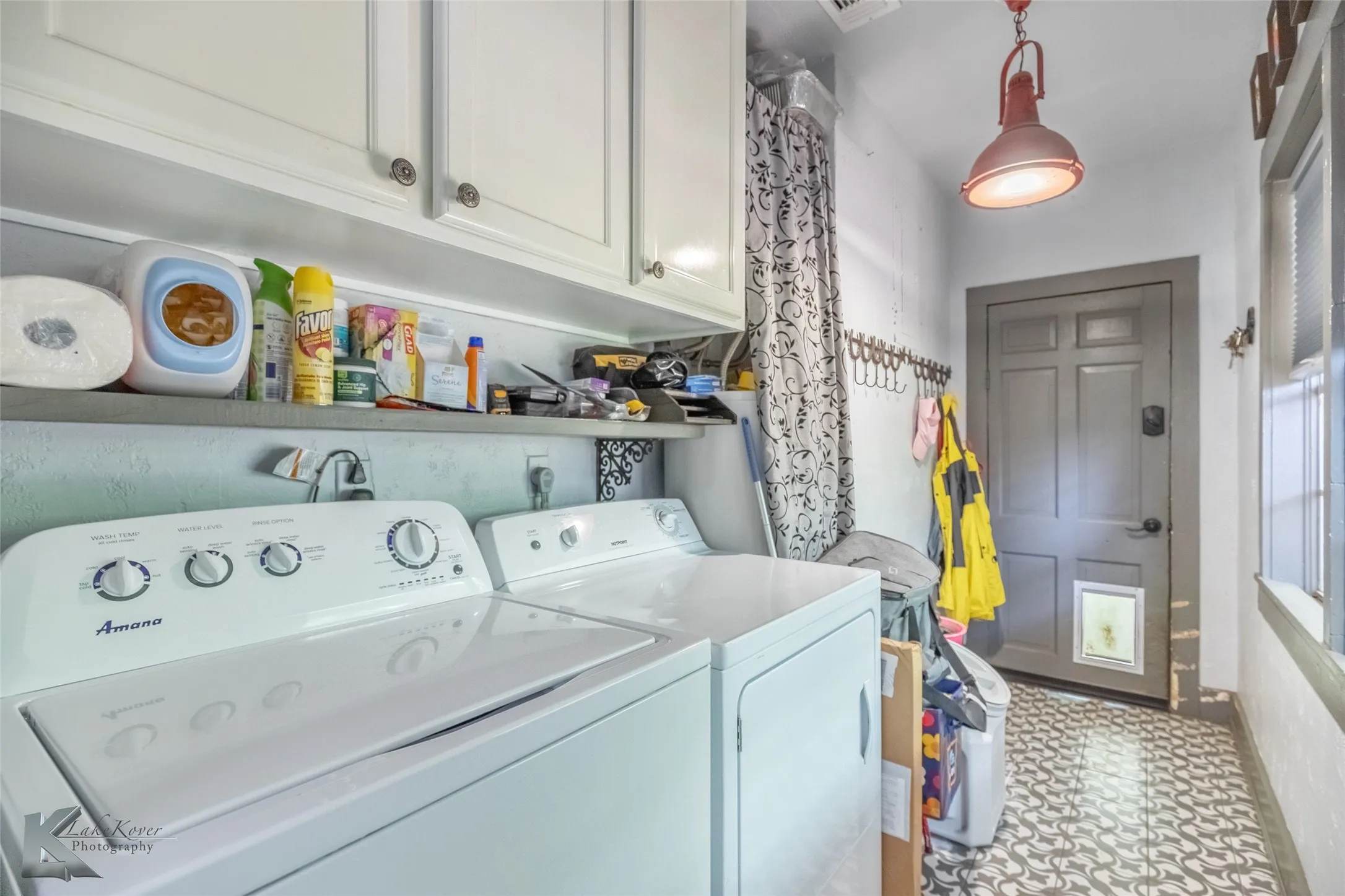 Laundry room with independent washer and dryer and cabinet space