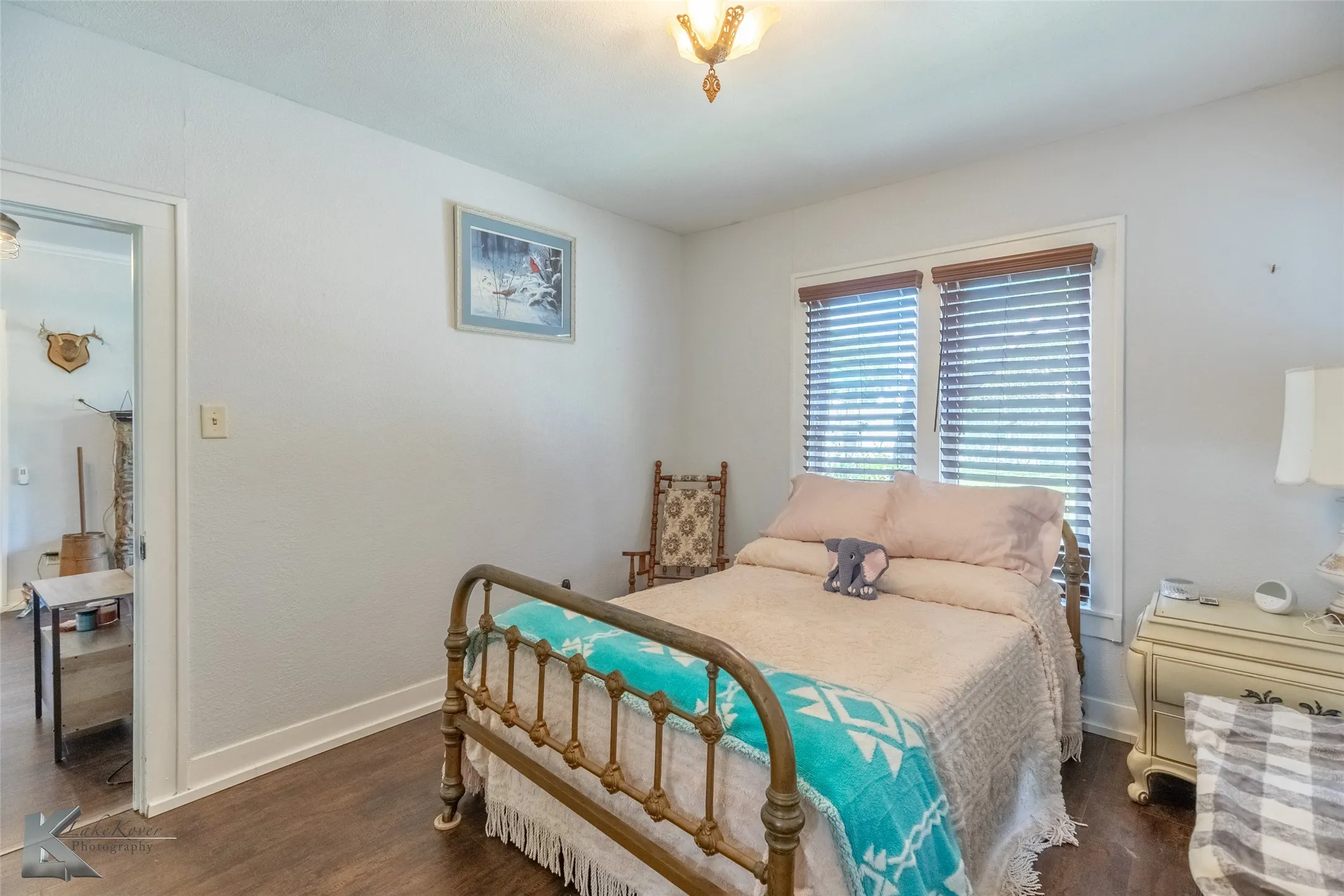 Bedroom with wood finished floors and baseboards