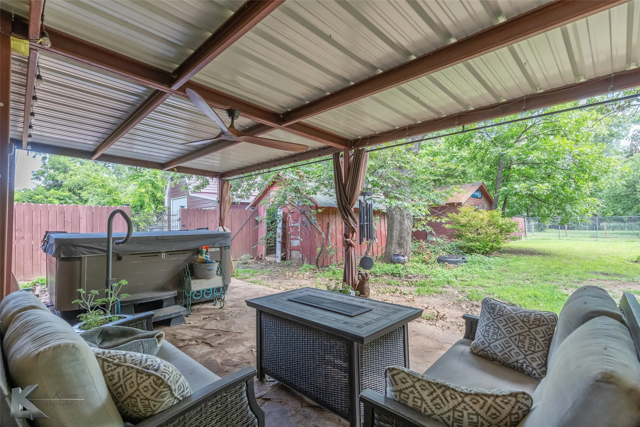 View of patio / terrace featuring a hot tub, an outdoor living space, and ceiling fan