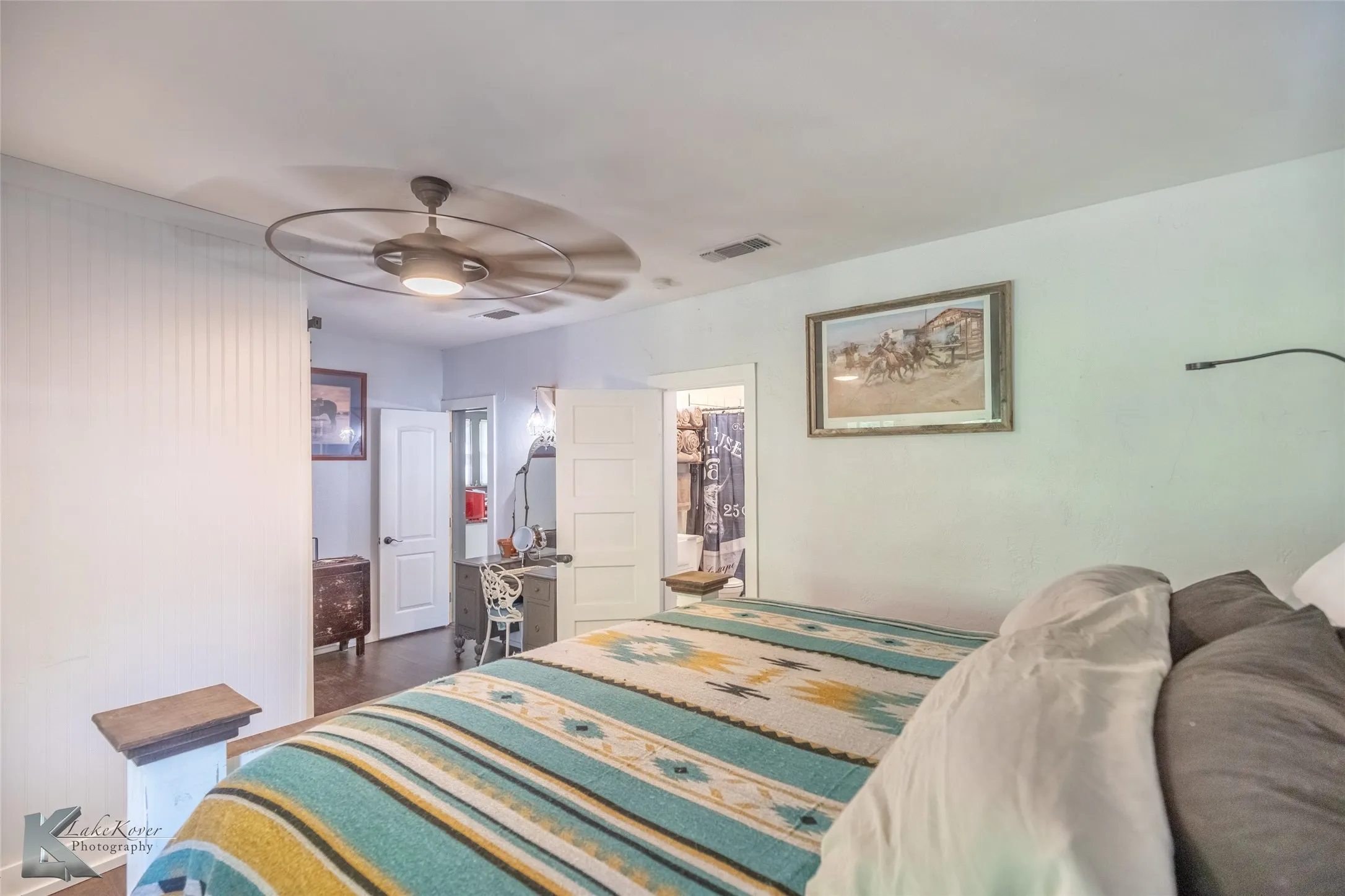 Bedroom with ceiling fan and dark wood-style flooring