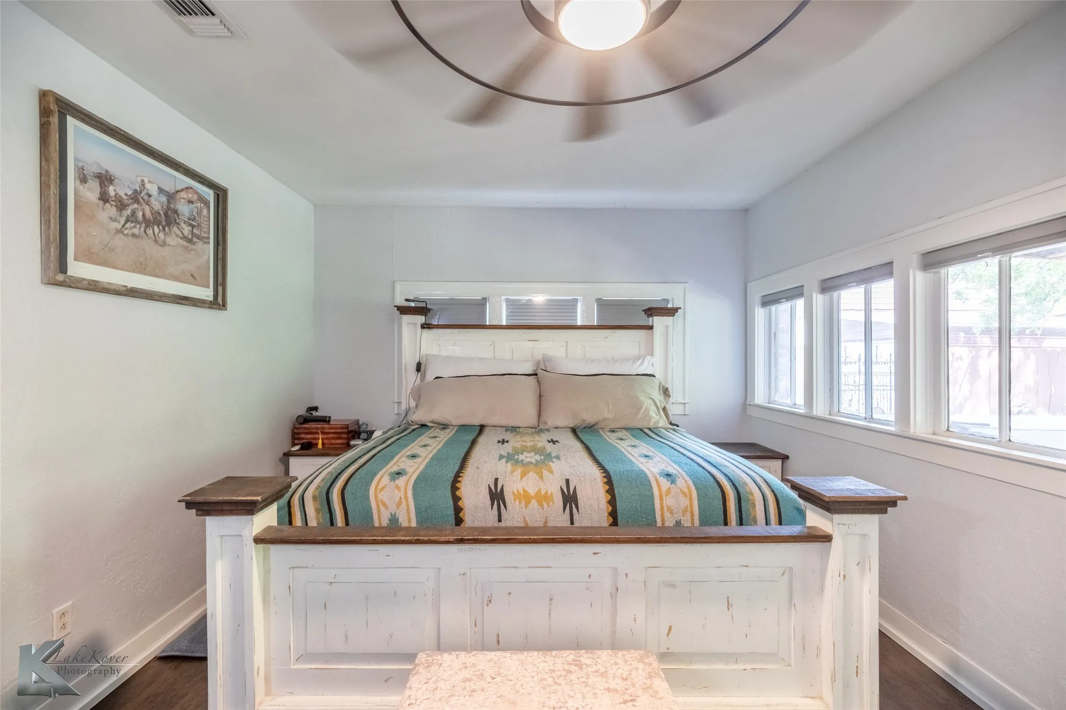 Bedroom with baseboards, wood finished floors, and ceiling fan