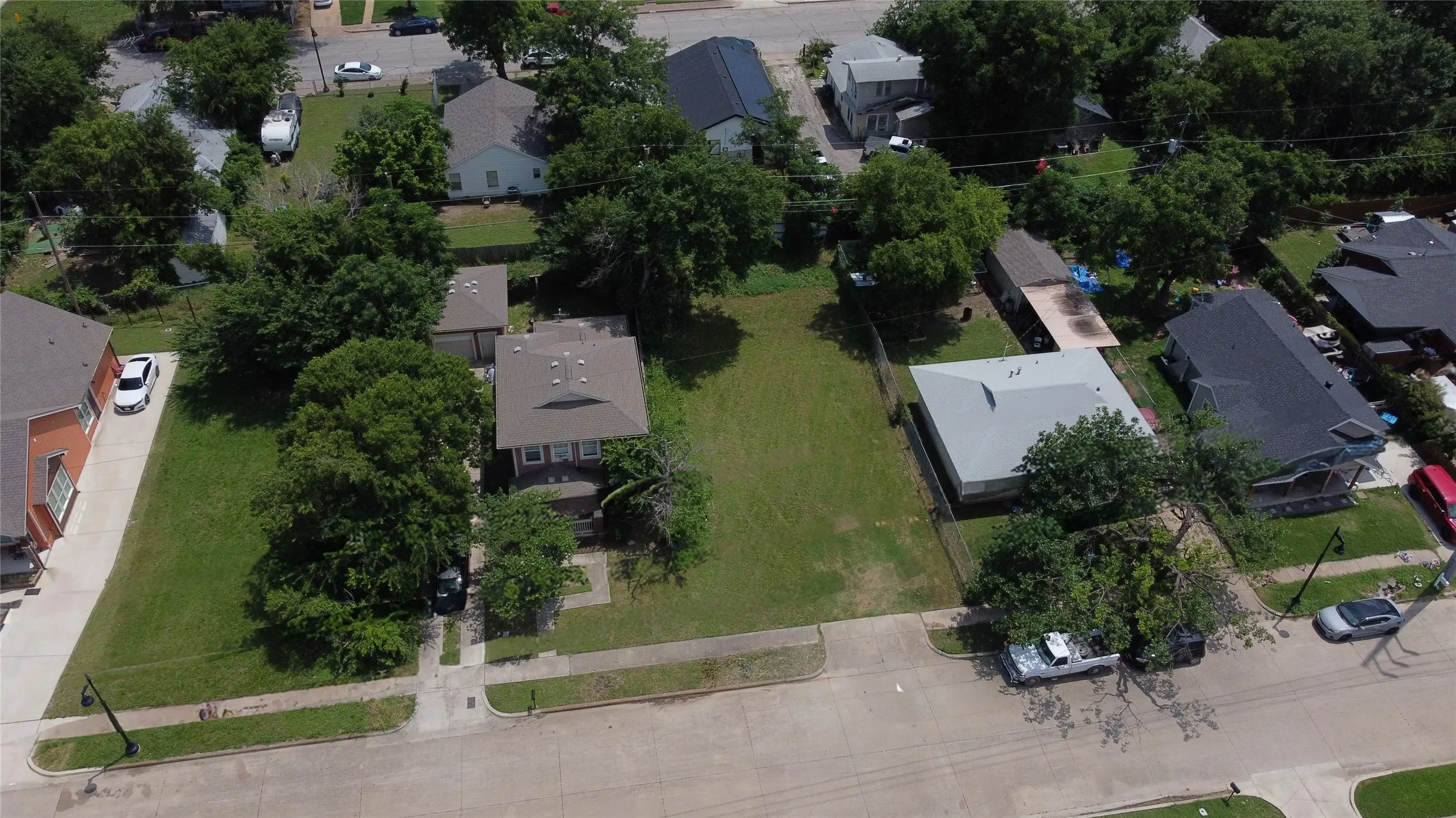 Aerial view of property and surrounding area featuring nearby suburban area