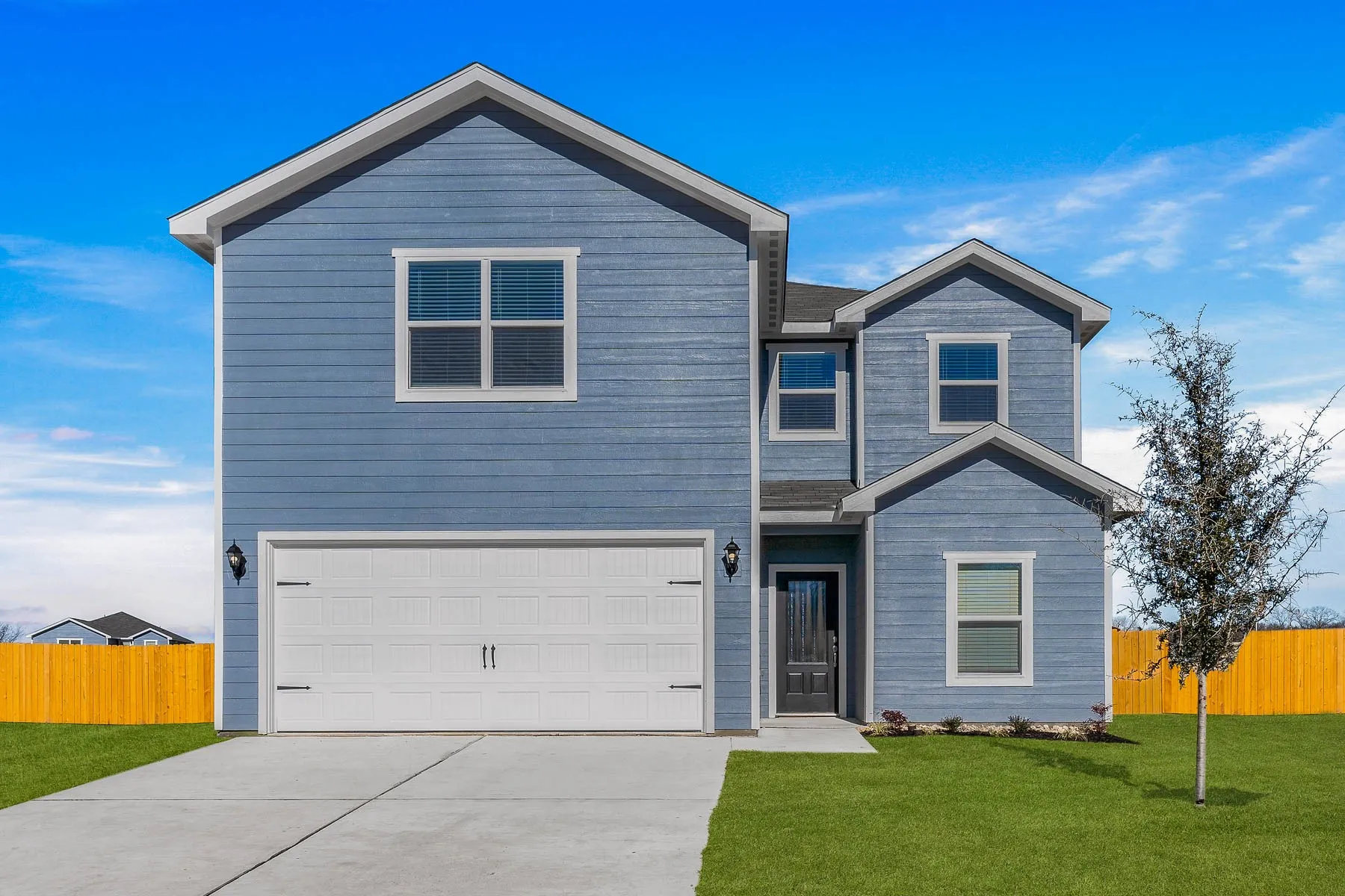 View of front facade with driveway and a garage