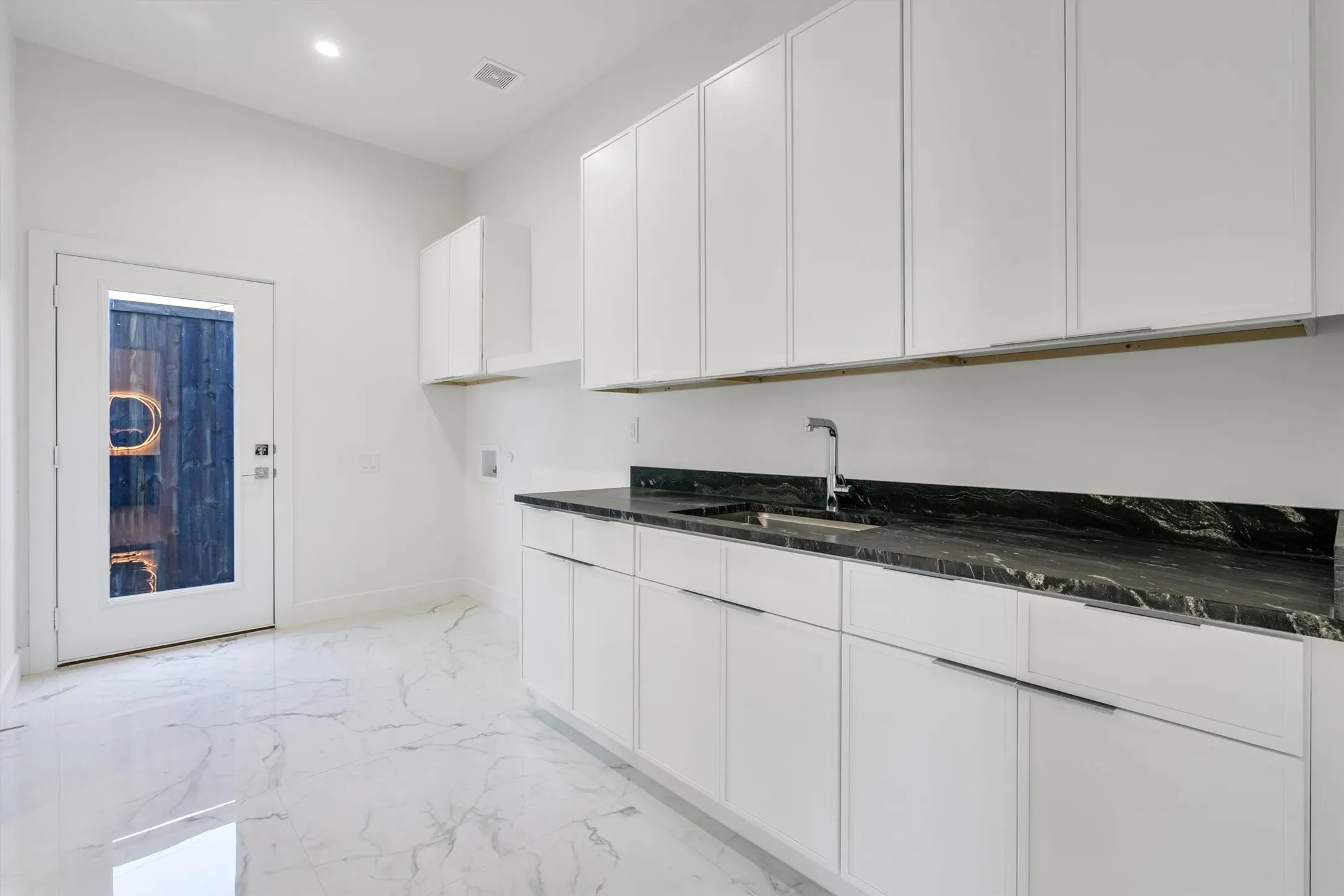 Laundry area featuring hookup for a washing machine, light marble finish flooring, cabinet space, baseboards, and recessed lighting